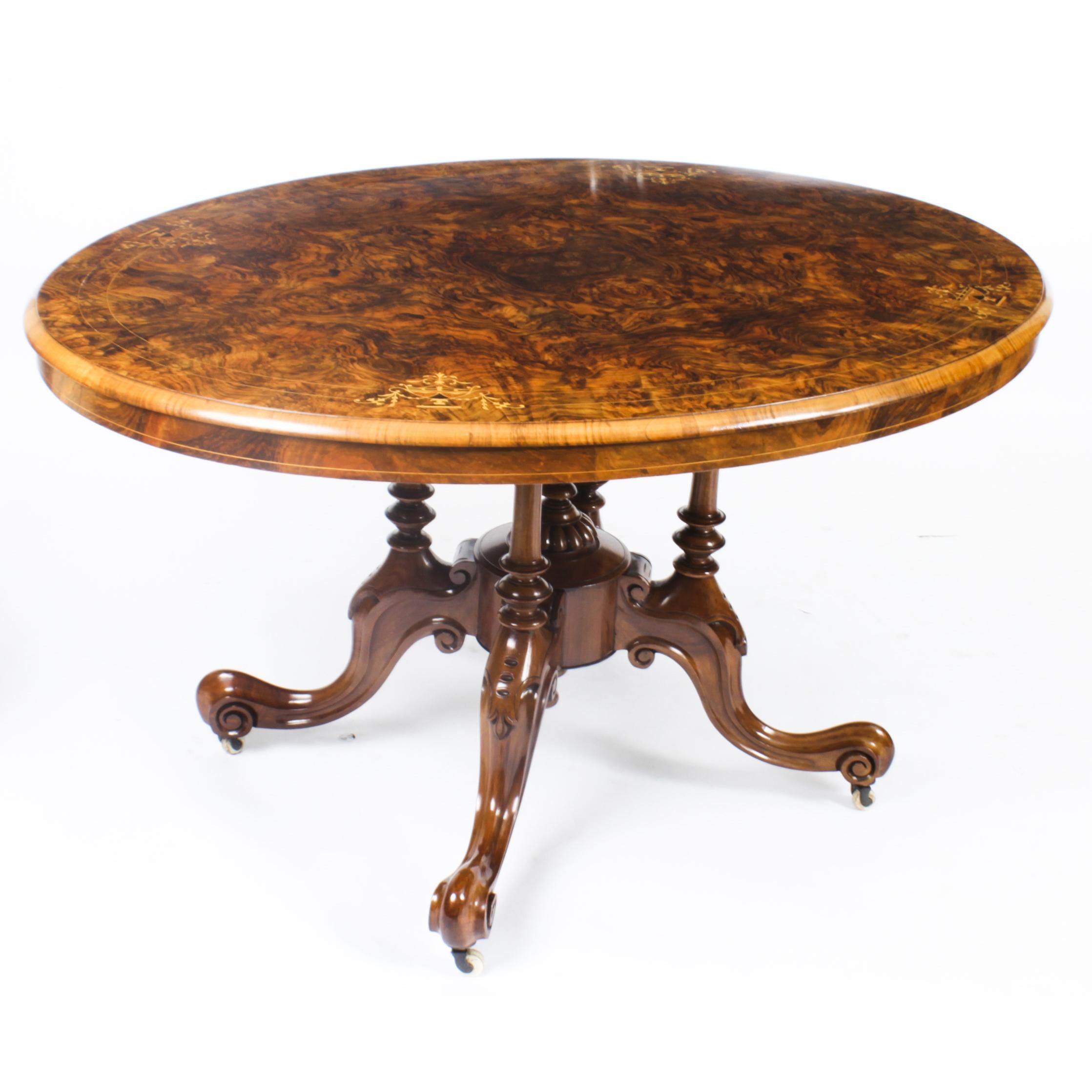 This is a superb large Victorian oval burr walnut Loo table, circa 1860 in date, with a set of four vintage balloon back chairs.
 
The beautifully figured quarter veneered oval tilt top table features superb marquetry inlaid decoration, a wonderful