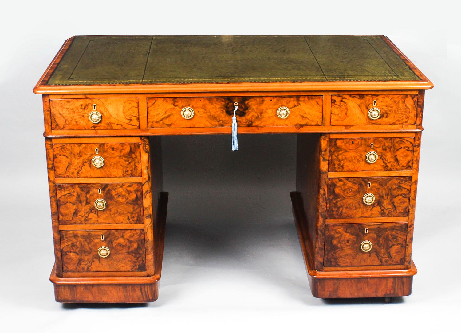 This is a superb antique Victorian burr walnut twin pedestal desk, circa 1860 in date.
 
It is made from fabulous burr walnut, the rounded rectangular top with a fabulous inset gold tooled green leather writing surface and it features an elegant