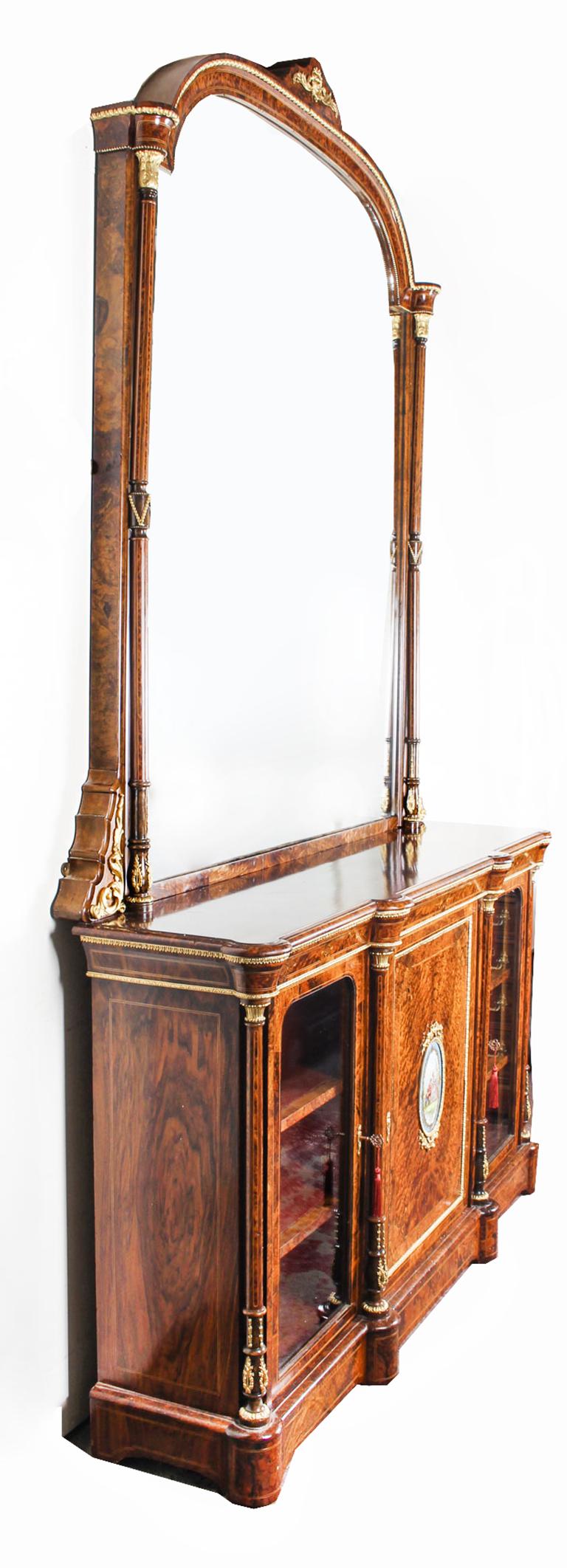 This is a monumental fine and rare antique Victorian burr walnut and amboyna, Sevres porcelain and ormolu-mounted breakfront mirror backed credenza, circa 1860 in date.
 
The well figured burr walnut top with perfectly matched veneers above a
