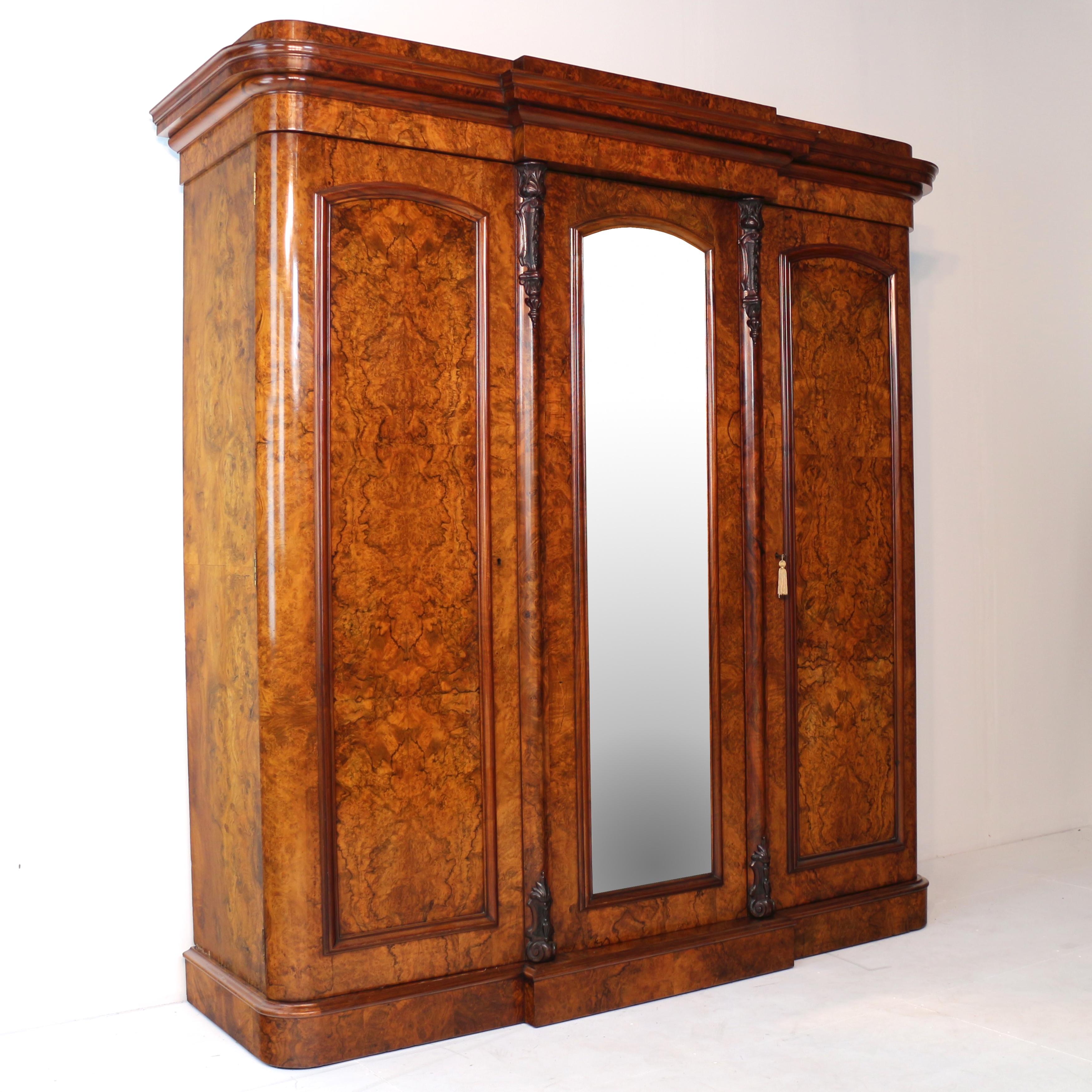 A fabulous Victorian breakfront fitted wardrobe of super quality and possibly by Wylie & Lochhead of Glasgow. Featuring well figured bookmatched burr walnut veneers to the front and sides and crisply carved acanthus leaf & harebell carved corbels.