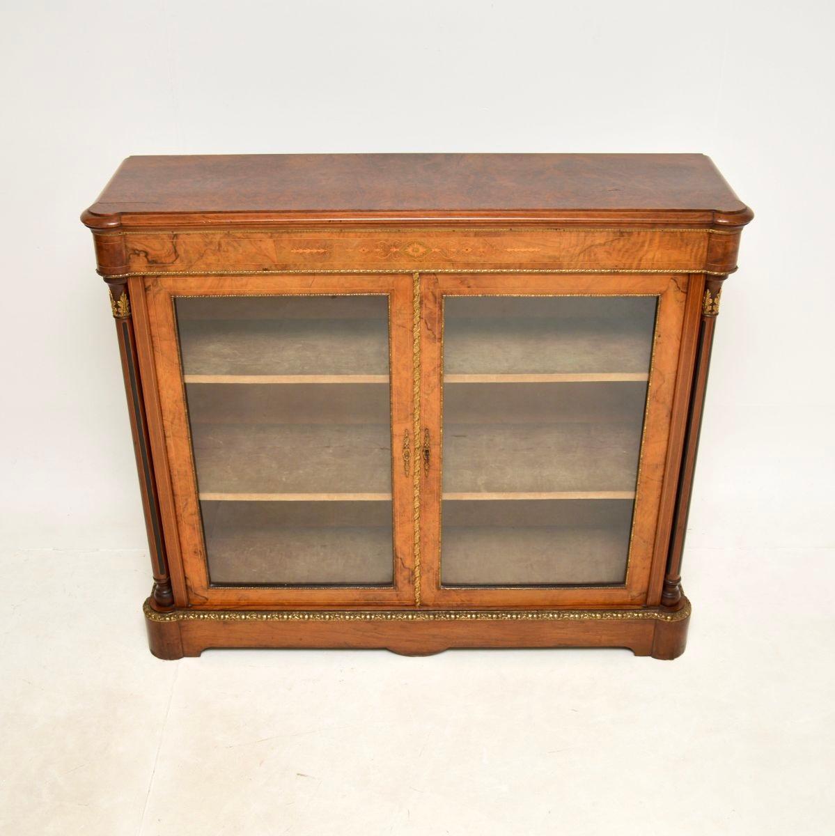 An absolutely stunning antique Victorian burr walnut twin pier cabinet / bookcase. This was made in England, it dates from around the 1860-1880 period.

It is of extremely fine quality and is a very useful size, with plenty of storage space. The