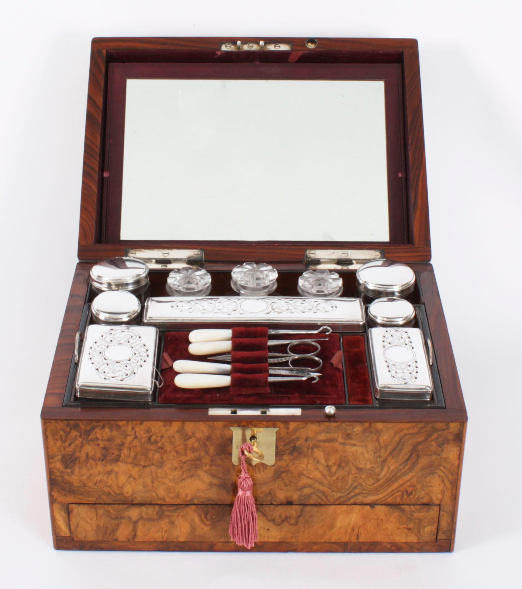 This is a magnificent antique Victorian Burr Walnut table top Vanity Box, circa 1860 in date.

The fitted interior reveals a lift-out tray, fitted with silver-plate mounted cut glass bottles, boxes, and jars, all finely engraved and pierced, the