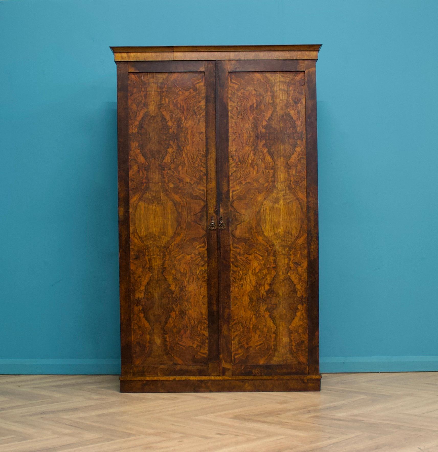 A stunning late Victorian burr walnut veneered wardrobe, circa 1860s
Featuring a rail the full width and brass handles


This wardrobe separates into two halves (plus a plinth and base)