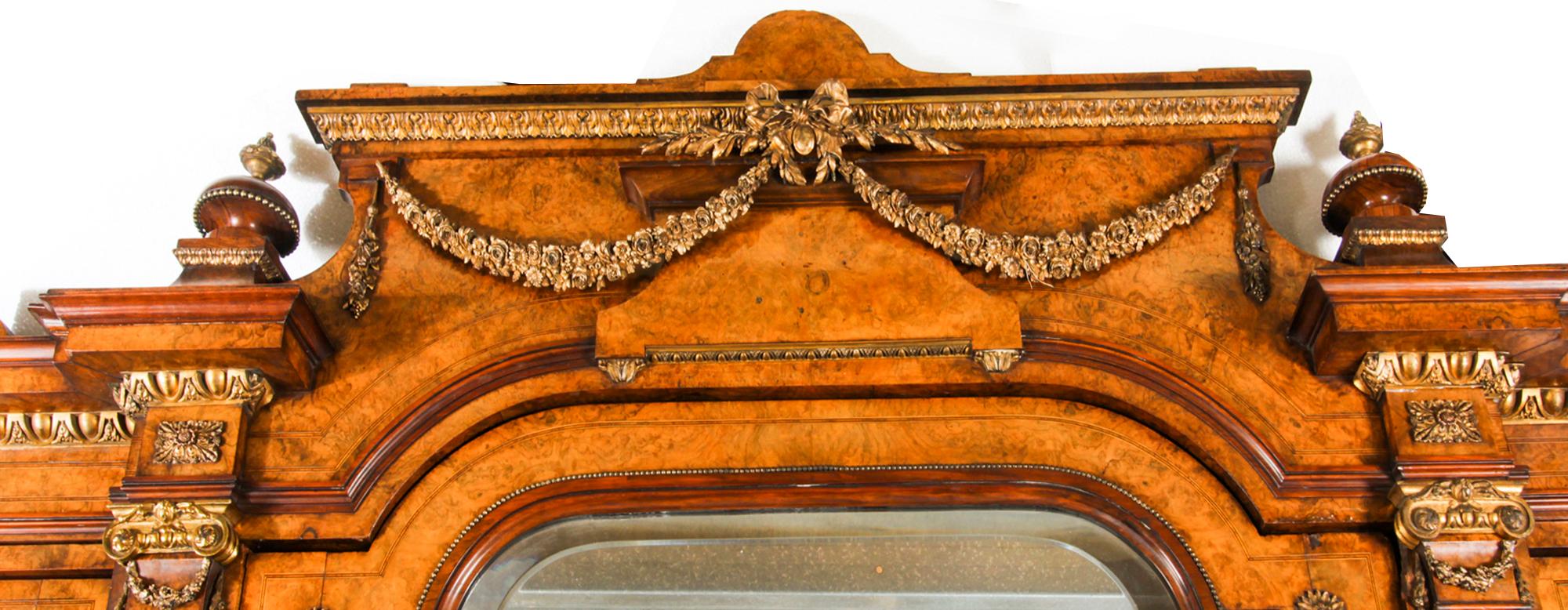 A fine Victorian Louis XVI style burr walnut and purplewood breakfront wardrobe attributed to Holland & Sons, circa 1860 in date.

The waldrobe is applied with gilt bronze mounts throughout and features a shaped moulded cornice with four turned