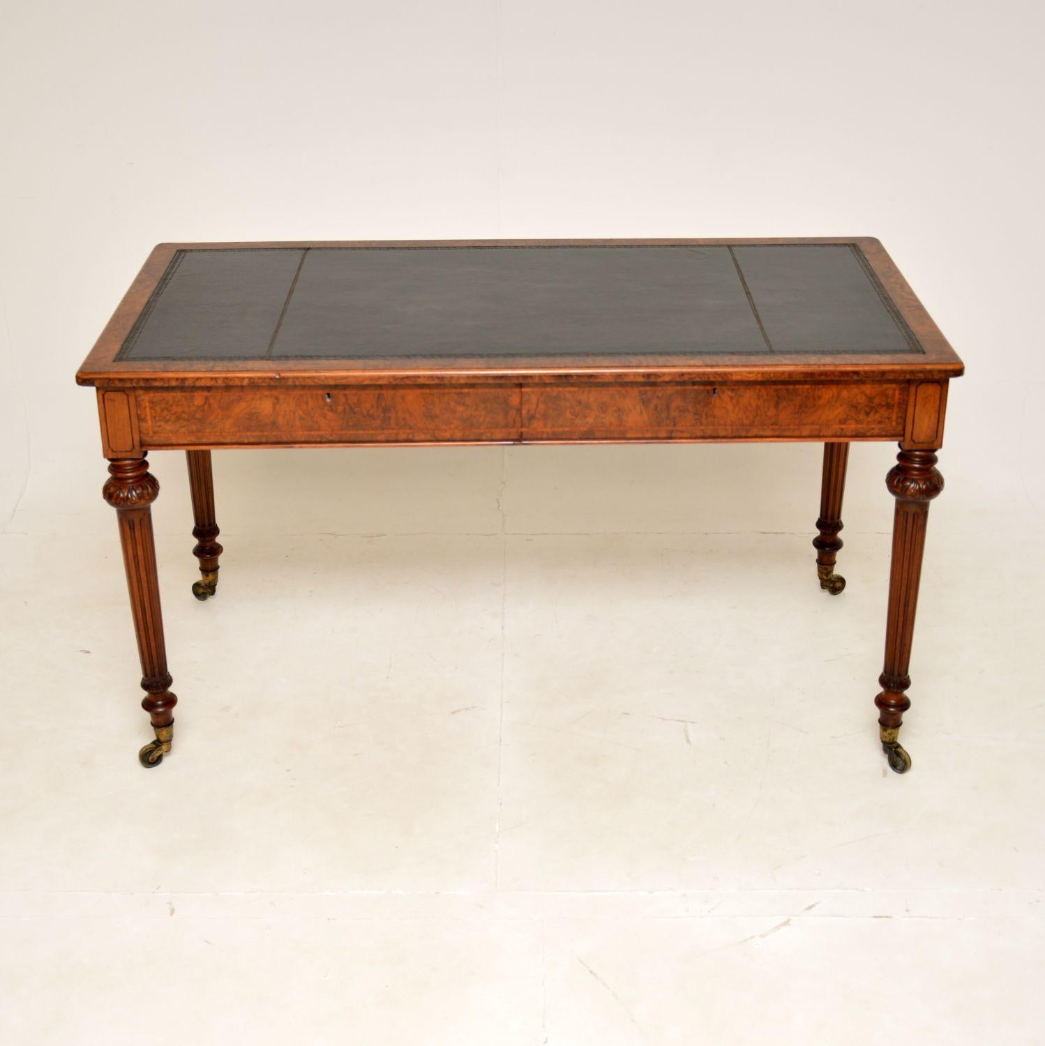 A superb antique Victorian leather top writing table / desk in burr walnut. This was made in England by Holland & Sons, it dates from around 1860-1880.

The quality is outstanding, this is as fine a writing table of the period as you could find. The