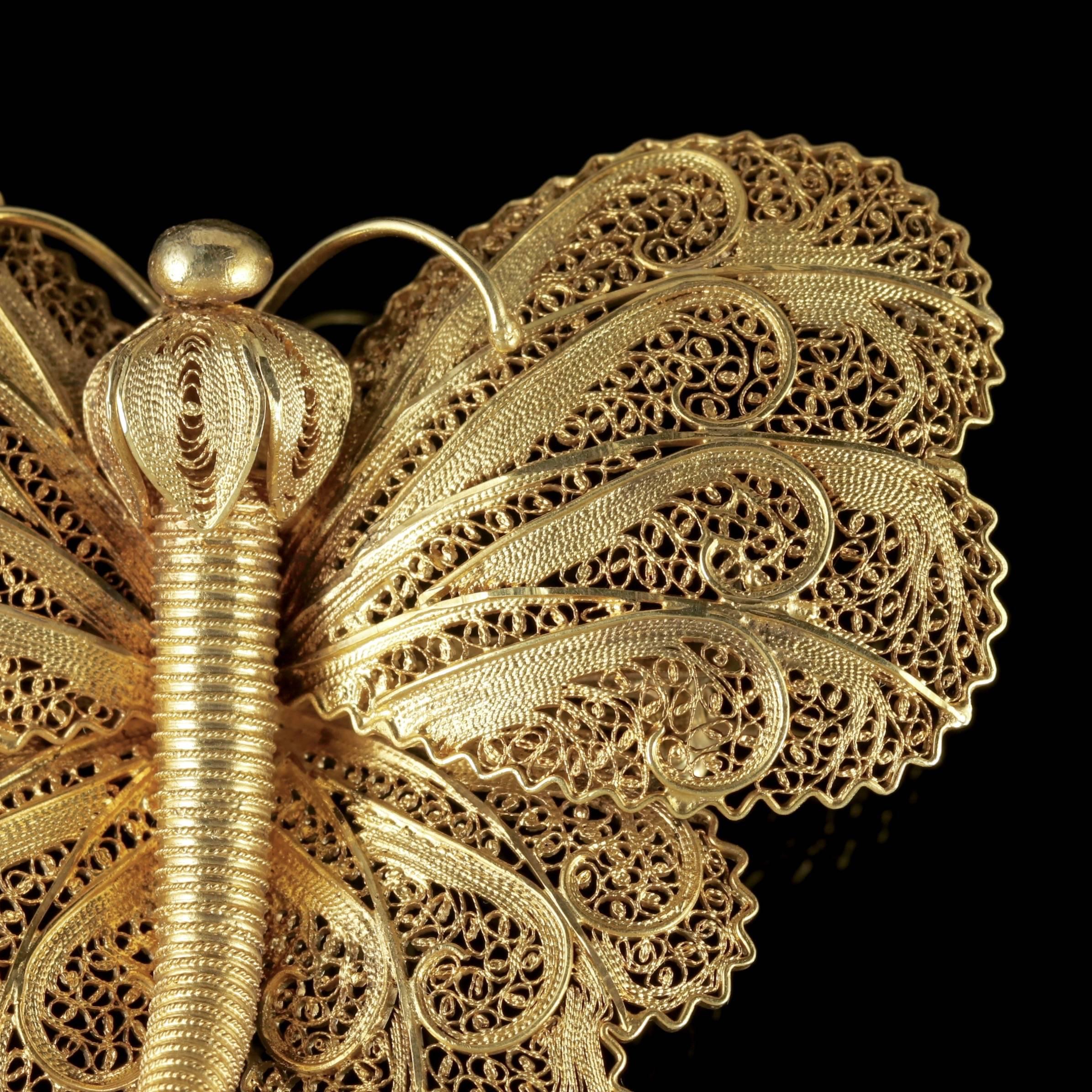 This stunning antique Victorian large golden butterfly brooch is Circa 1900. 

The fabulous abstract butterfly displays beautiful, detailed workmanship with decorative wings and head that almost look like golden flower petals.

The body and tail are