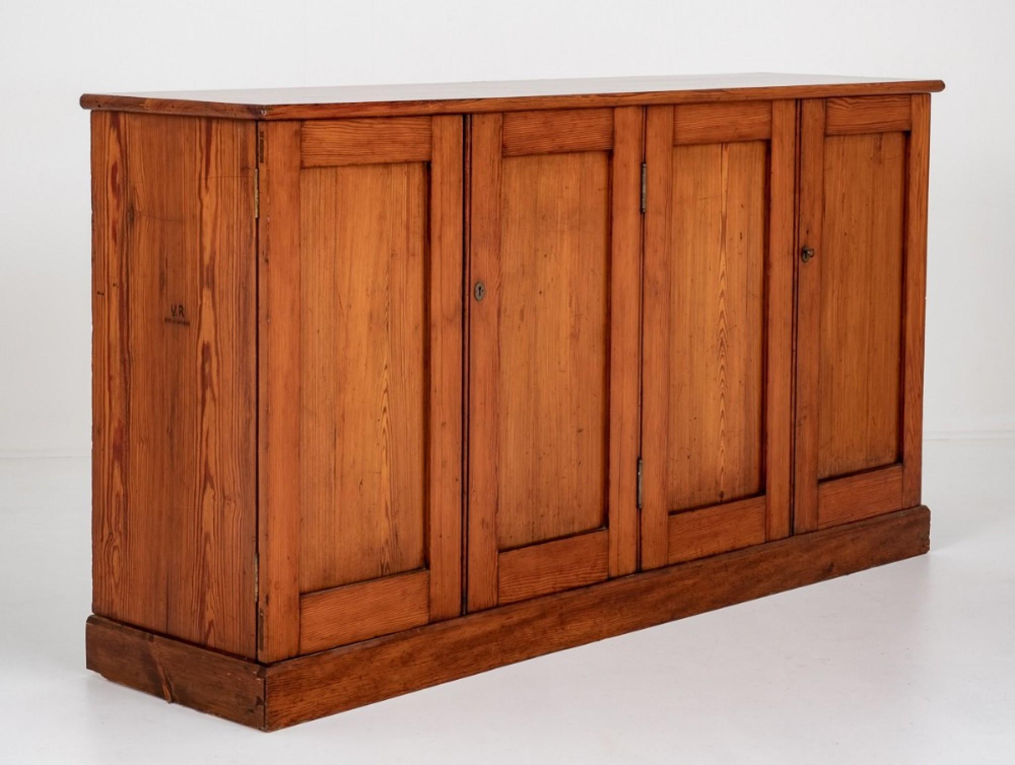 Antique Pitch Pine Cabinet.
This Cabinet is raised Upon a Plinth Base with 4 Doors.
The Doors Open To reveal A shelved Interior, great storage solution.
Circa 1880
The Cabinet Features a Makers Stamp 