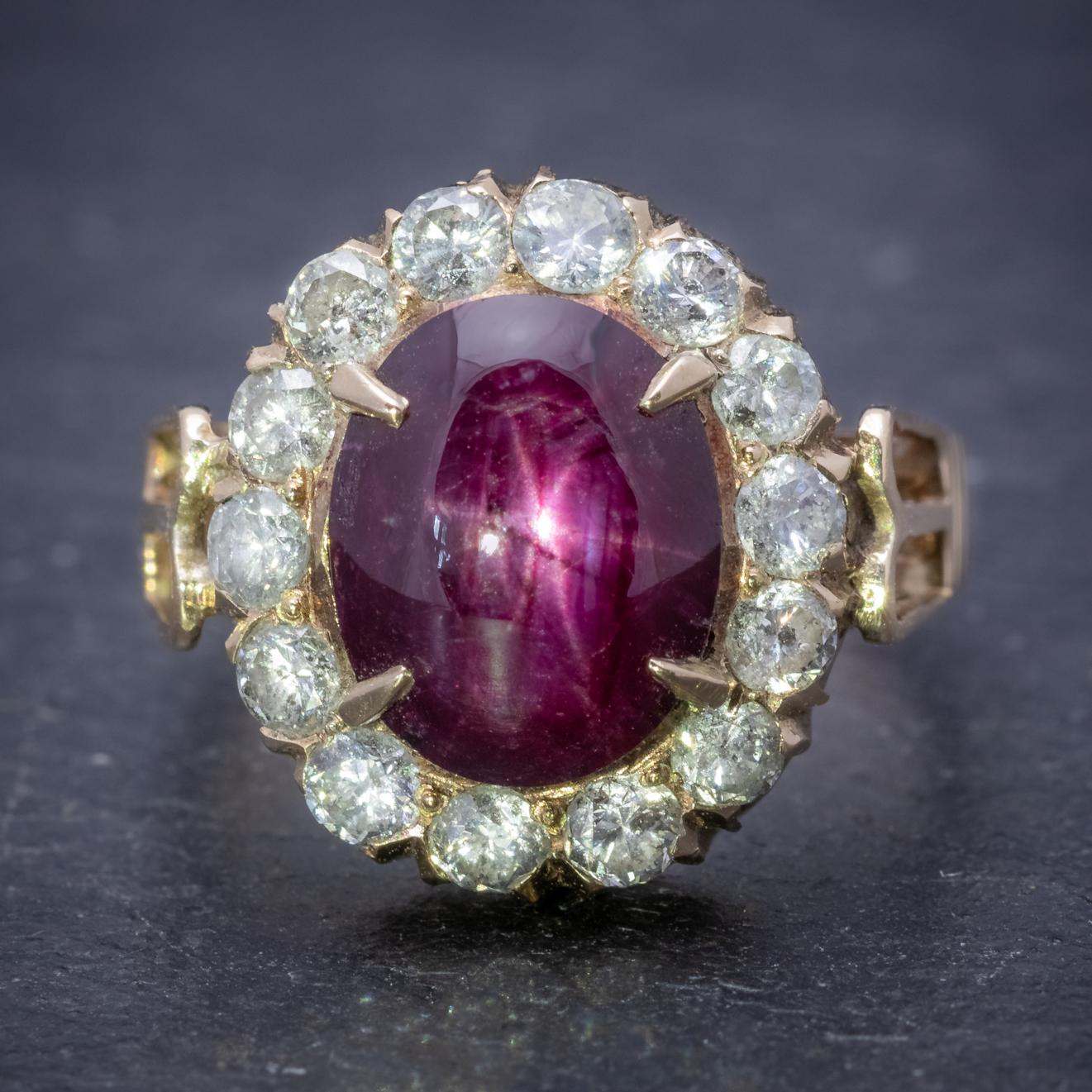 This magnificent antique Victorian cluster ring is adorned with a natural 3ct Star Ruby which is a lovely deep red colour and features a mystifying glow that shimmers across the surface in the shape of a star. 

The Ruby is surrounded by a halo of