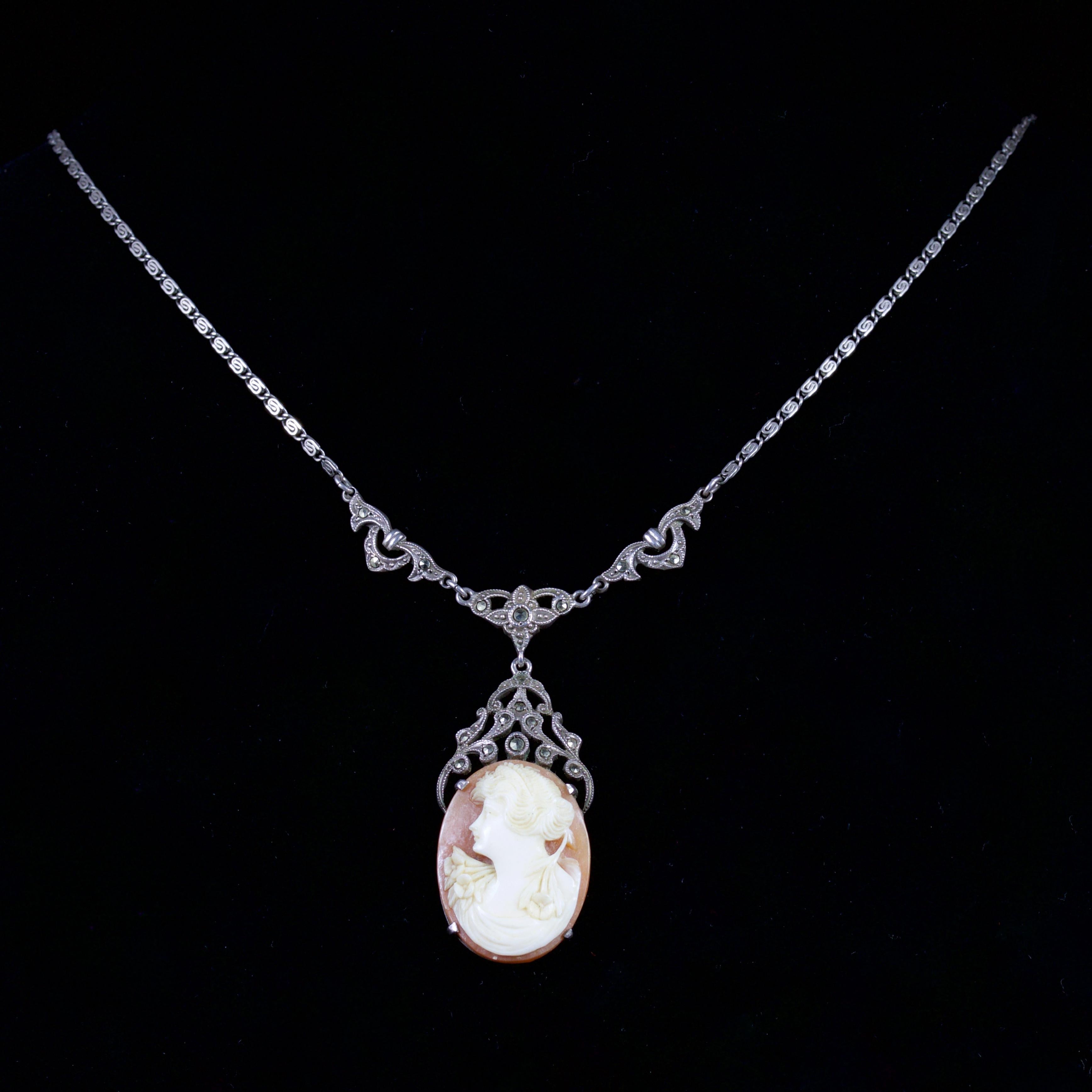 This beautiful Cameo and Marcasite necklace is set in Sterling Silver, Circa 1900.

The necklace boasts a well executed Cameo, which is hand-carved.

The Cameo is surrounded by Marcasites in a pierced Silver Motif.

It is surrounded by a pierced and