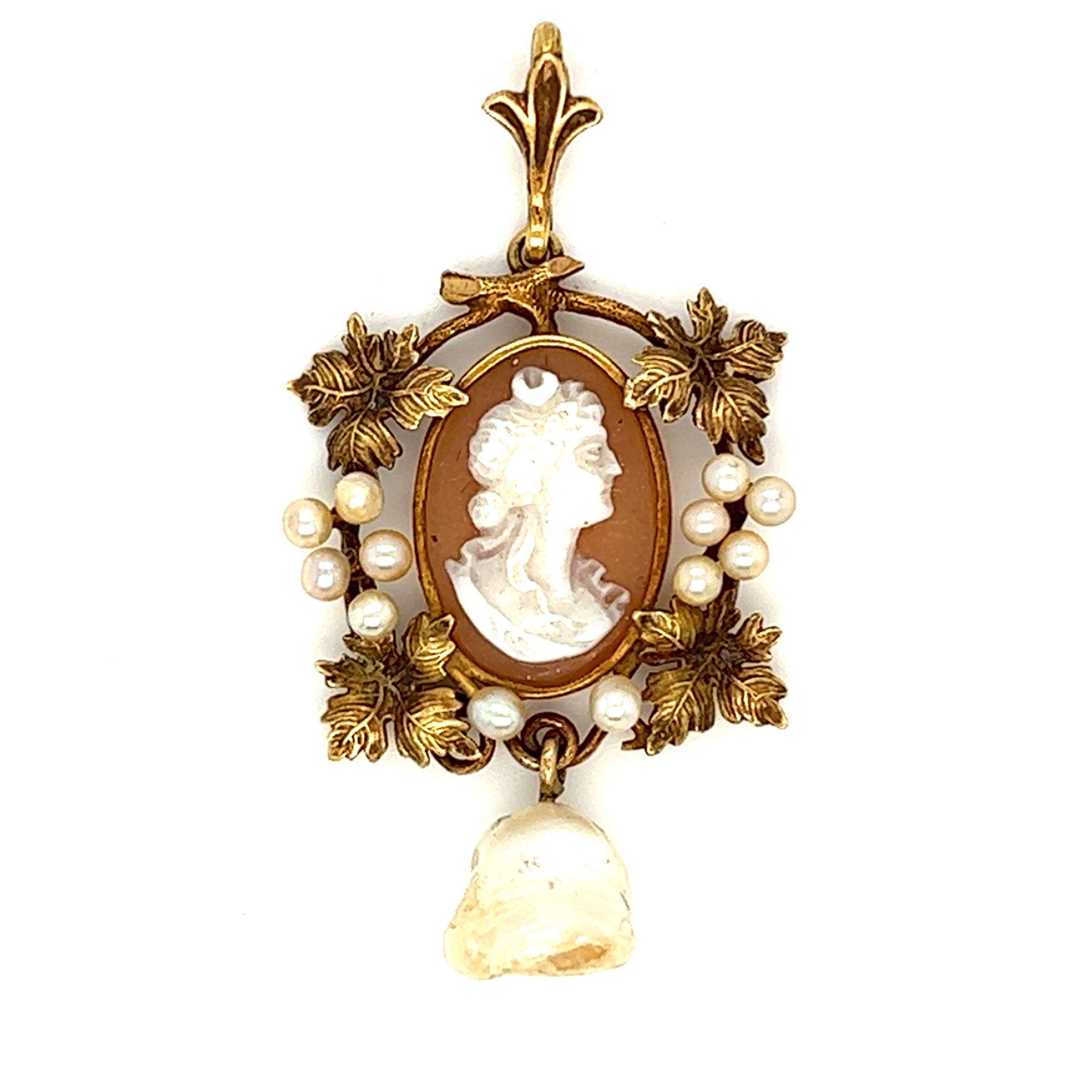 From victorian era, this lavalier cameo with beautiful silhouette of a woman features seed pearls and figural leaf and twig around the cameo. The off shape pearl dangles at bottom of the pendant.

Measurement: 3/4 x 1 1/2 inch
Gross Weight: 2.7 grams