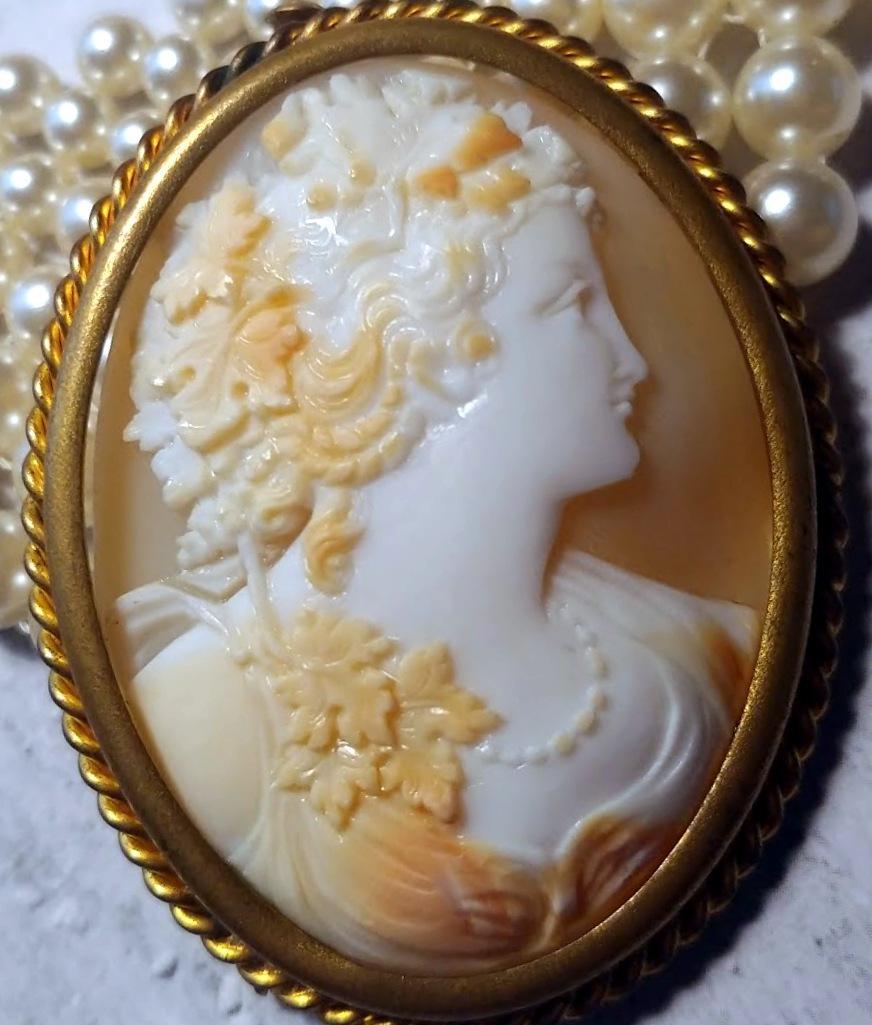 We are thrilled to offer you a beautifully carved Victorian Carved Cameo Brooch from the late 19th century to the early 20th century. The stunning portrait of a young woman as a Bacchante on this brooch is executed with incredible skill and detail,