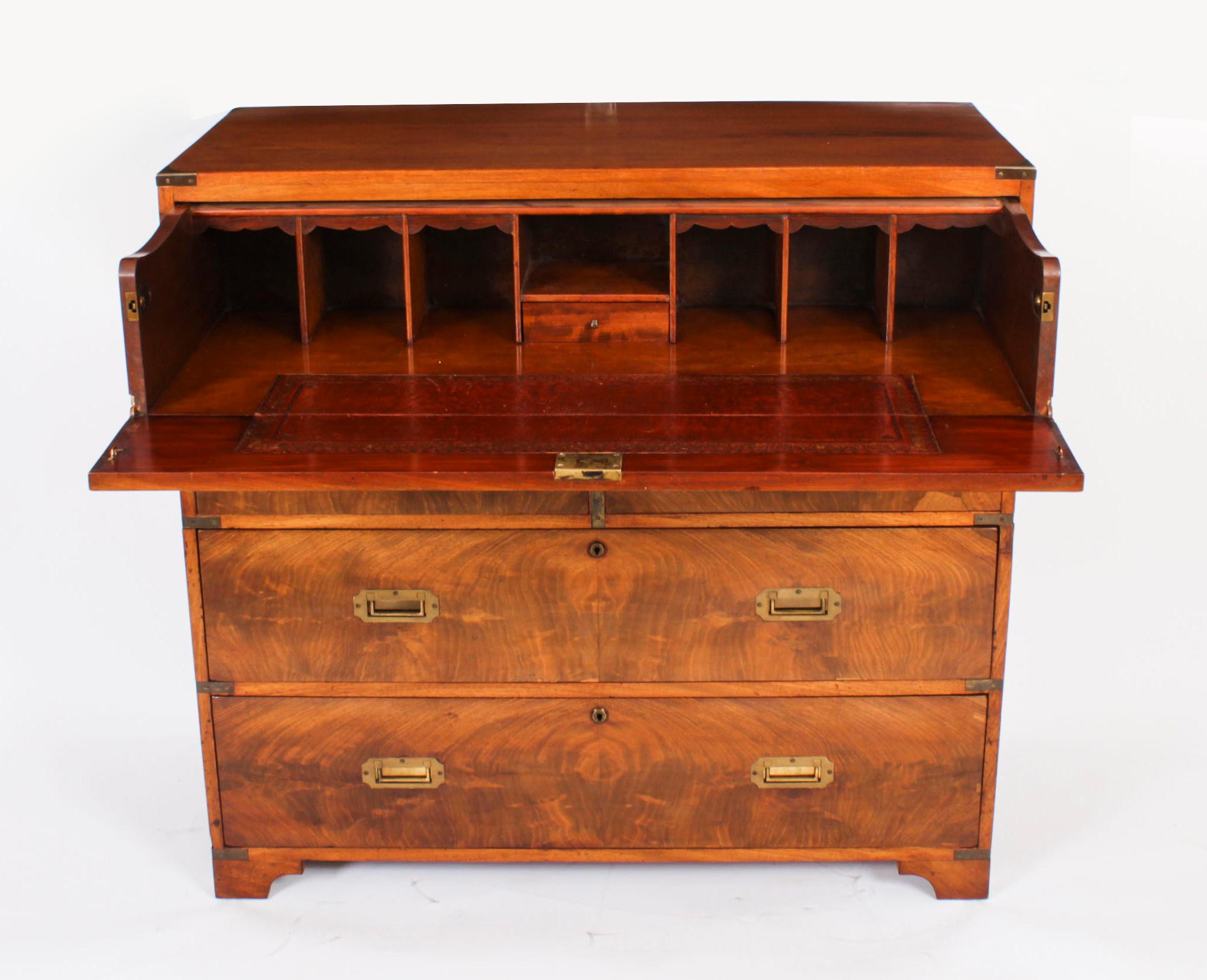 This is beautifully crafted antique early Victorian teak military campaign secretaire chest of drawers dates from Circa 1840.

The top drawer opening to a pull out secretaire fitted with a small drawer, pigeon hole compartments and an inset gold