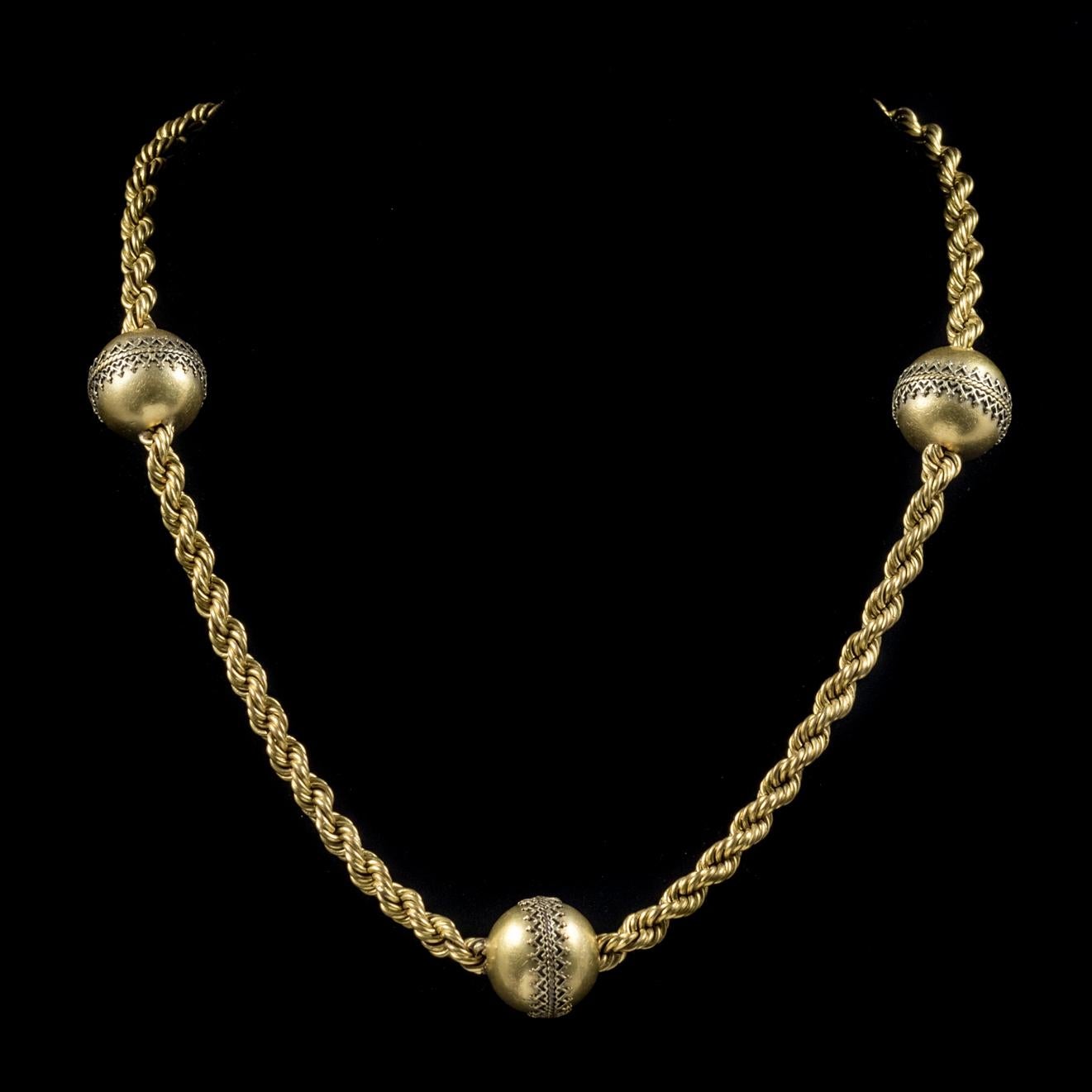 This genuine antique Cannetille Gold ball necklace is from the Victorian era, Circa 1860.

The heavy rope twist chain is beautifully made and features three large Cannetille balls across the piece. 

Cannetille is an intricate three dimensional