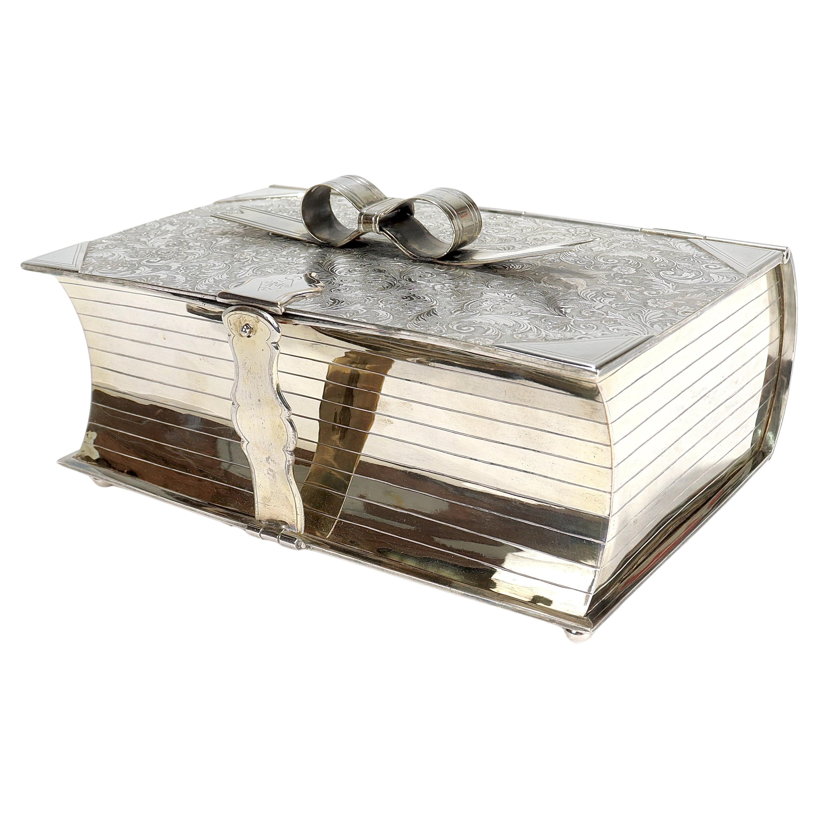 A fine antique figural Victorian silver plated humidor.

In the trompe l'oeil form of a book marked 