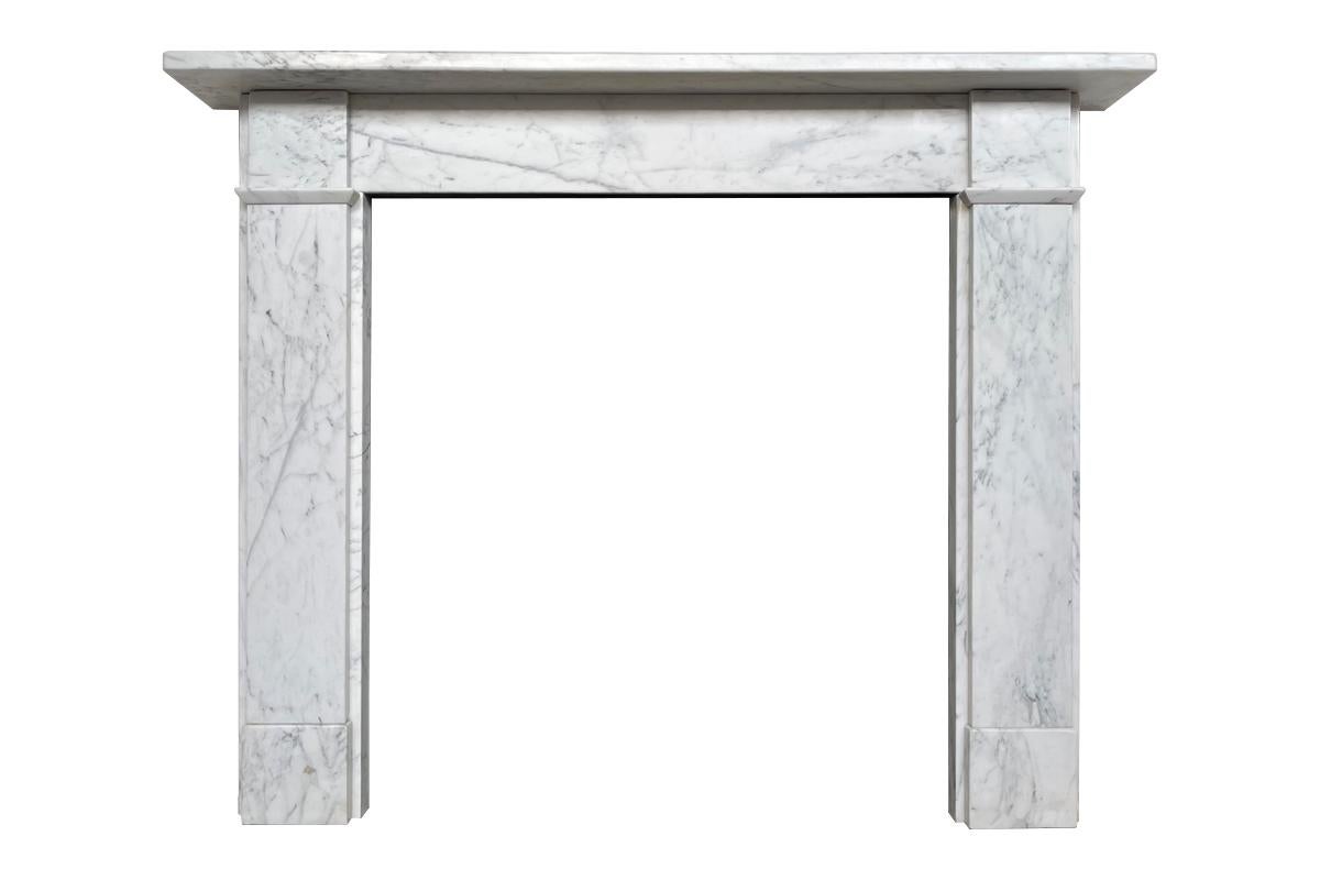 An antique Victorian fireplace surround of simple form in well figured Carrara marble. Plain jambs sit on square plinths and terminate in unadorned square capitals. Circa 1880.

For detailed sizes please see the size diagram in the image