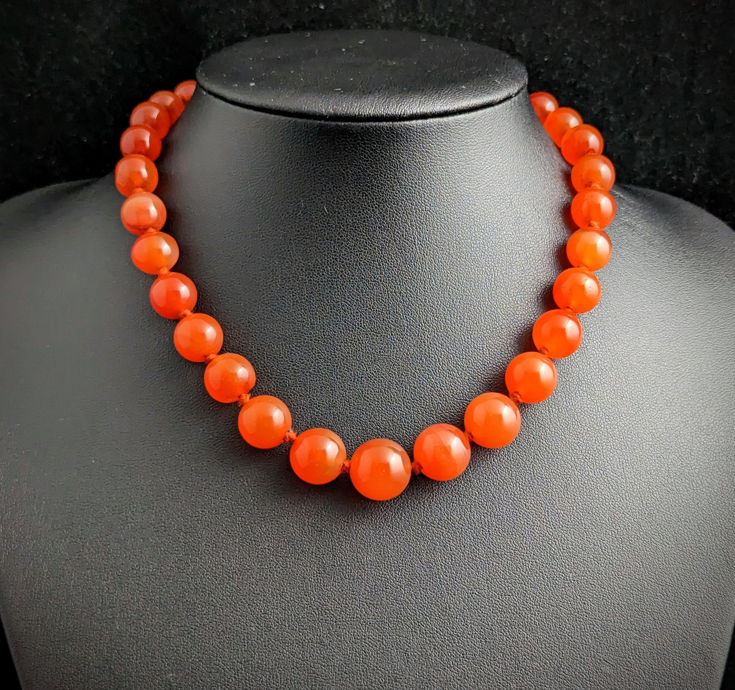 This antique Victorian era Carnelian bead necklace is so gorgeous and chunky.

Big, bold Carnelian beads, graduating in size, in a rich orangey red with light coloured streaks ranging from clear to Orange hues.

The beads have been hand knotted onto
