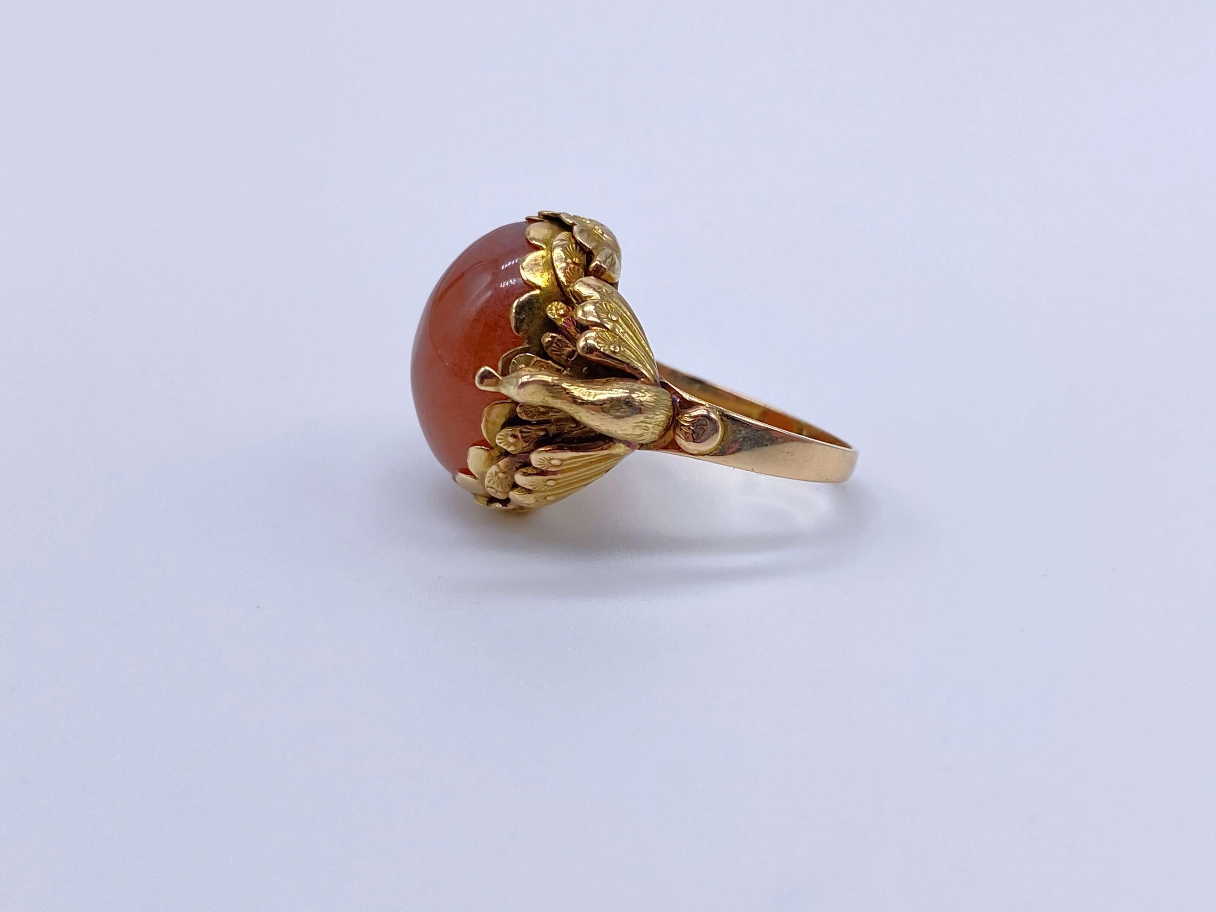 Precioso anillo de finales de la época victoriana con una importante piedra central de cornalina. Este anillo tiene un hermoso trabajo de oro con volantes alrededor de la piedra. Dos pavos reales están suspendidos justo encima de la caña.

Estado: