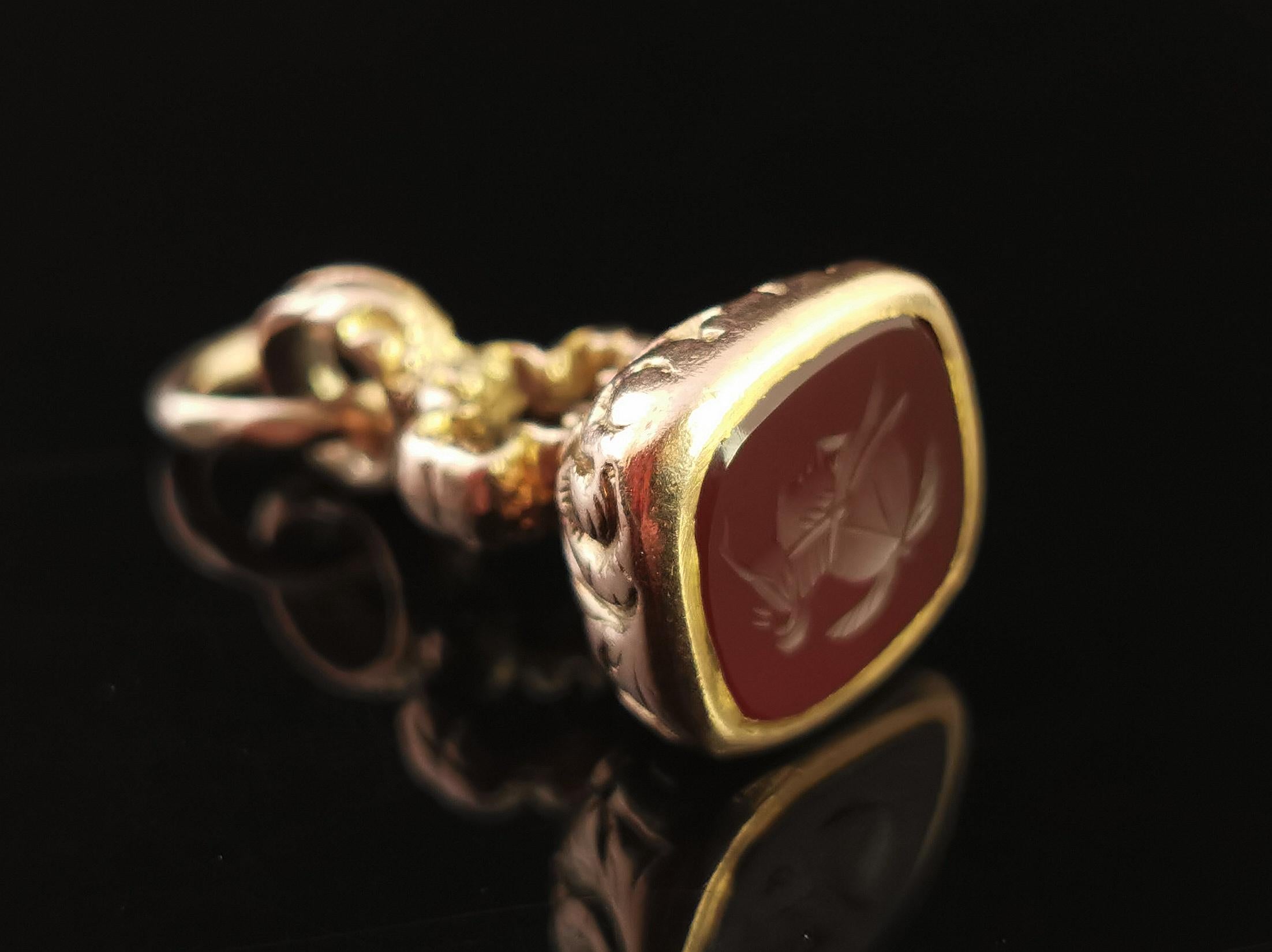 A beautiful antique, late Georgian era 9 karat yellow gold and Carnelian seal fob.

It is a very decorative seal fob with a chased and engraved base and a cross design to the centre, the base set with a rich red Carnelian stone.

The matrix has been