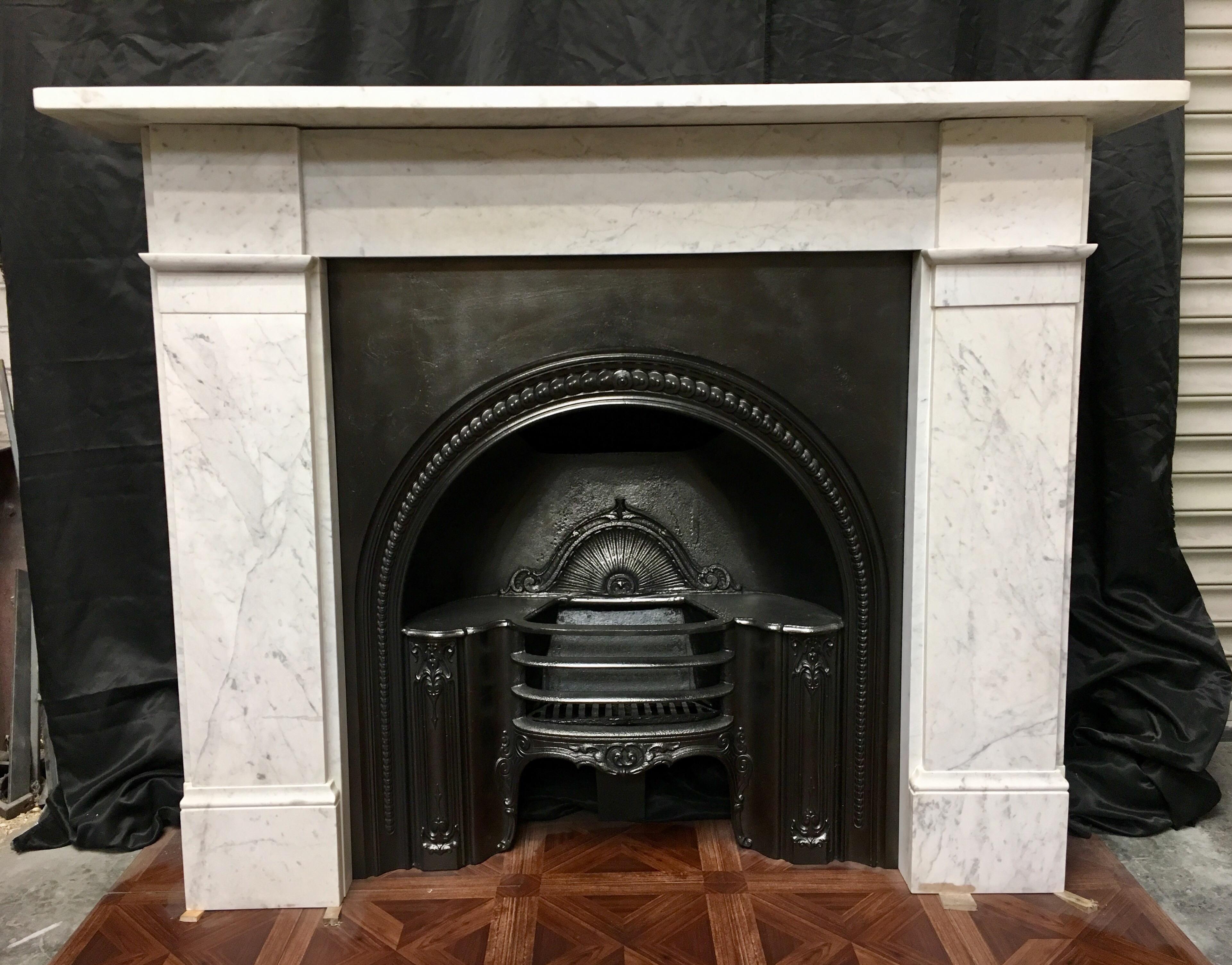 A simple, but attractive Classic antique Victorian Carrara marble fireplace surround, a square shelf sits above a plain frieze, flanked by a pair of unadorned jambs with block and moulding to the lower frieze level, finishing on moulded foot