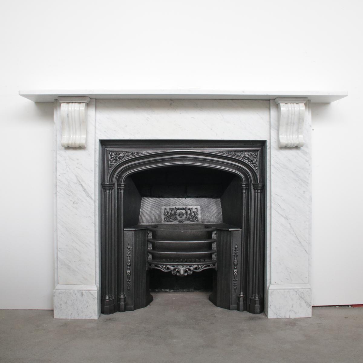 Antique Victorian Carrara marble fireplace surround with fluted corbels supporting the shelf, circa 1880.

 