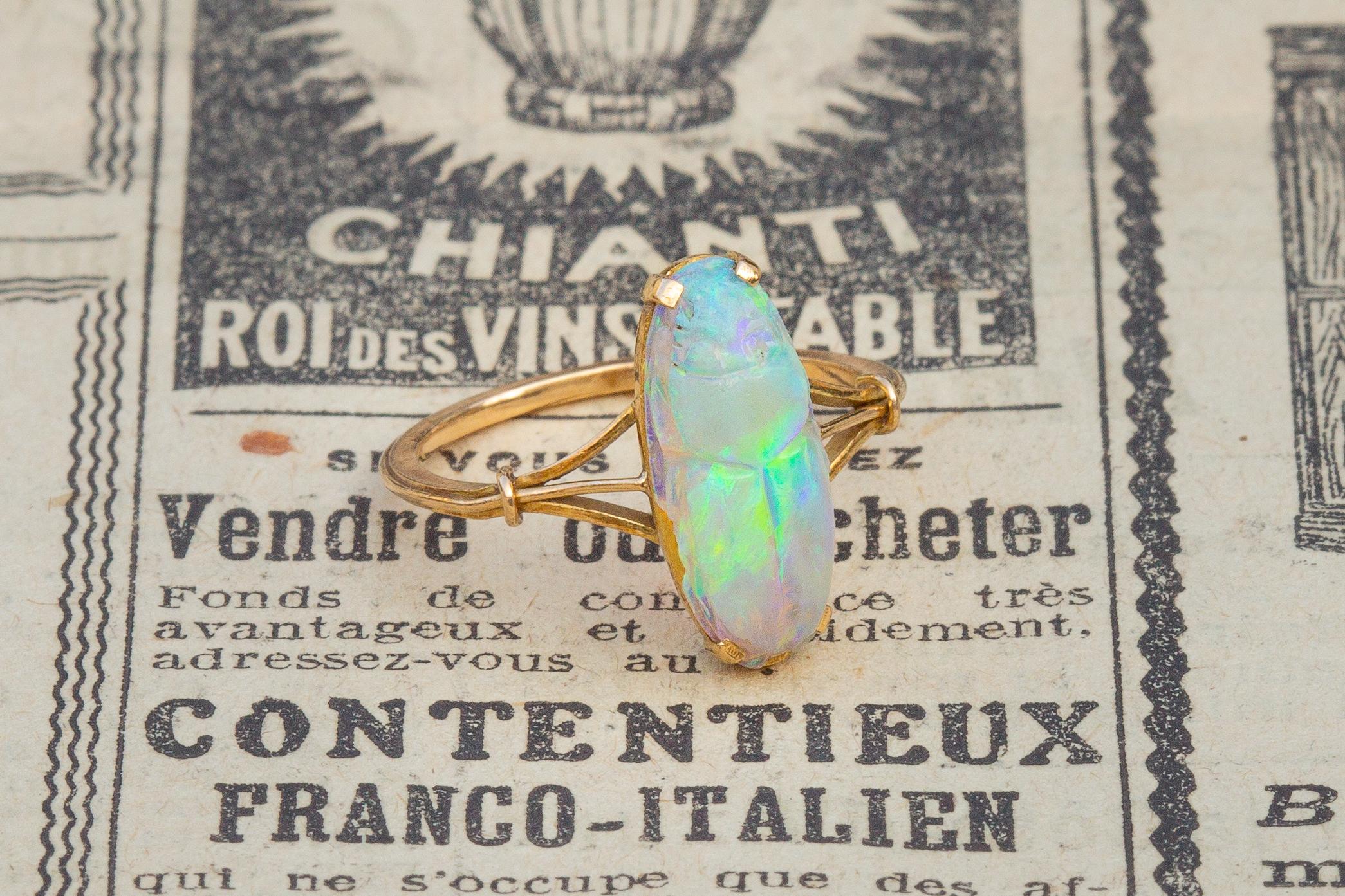A beautiful 18K gold and opal ring dating from the late Victorian period, circa 1900. It features a centrally mounted opal scarab.
The scarab is carved from a single piece of opal and weighs approximately 2.13 carats. 

The opal is a lovely specimen