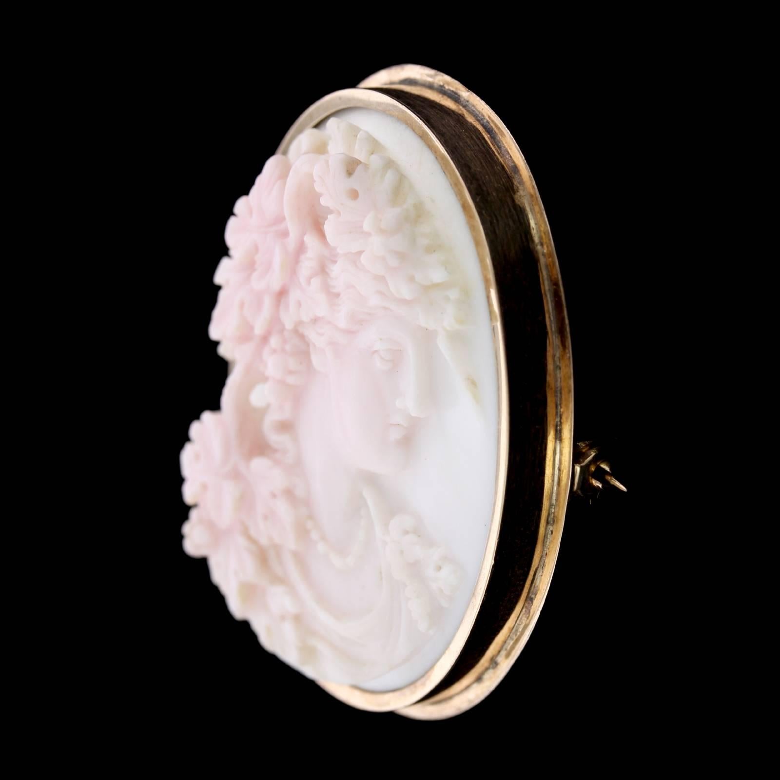 Antique Victorian Carved Coral Cameo Brooch. The brooch is set with a carved coral cameo depicting a woman in profile, measuring 39.00 x 31.00mm., length 1 3/4