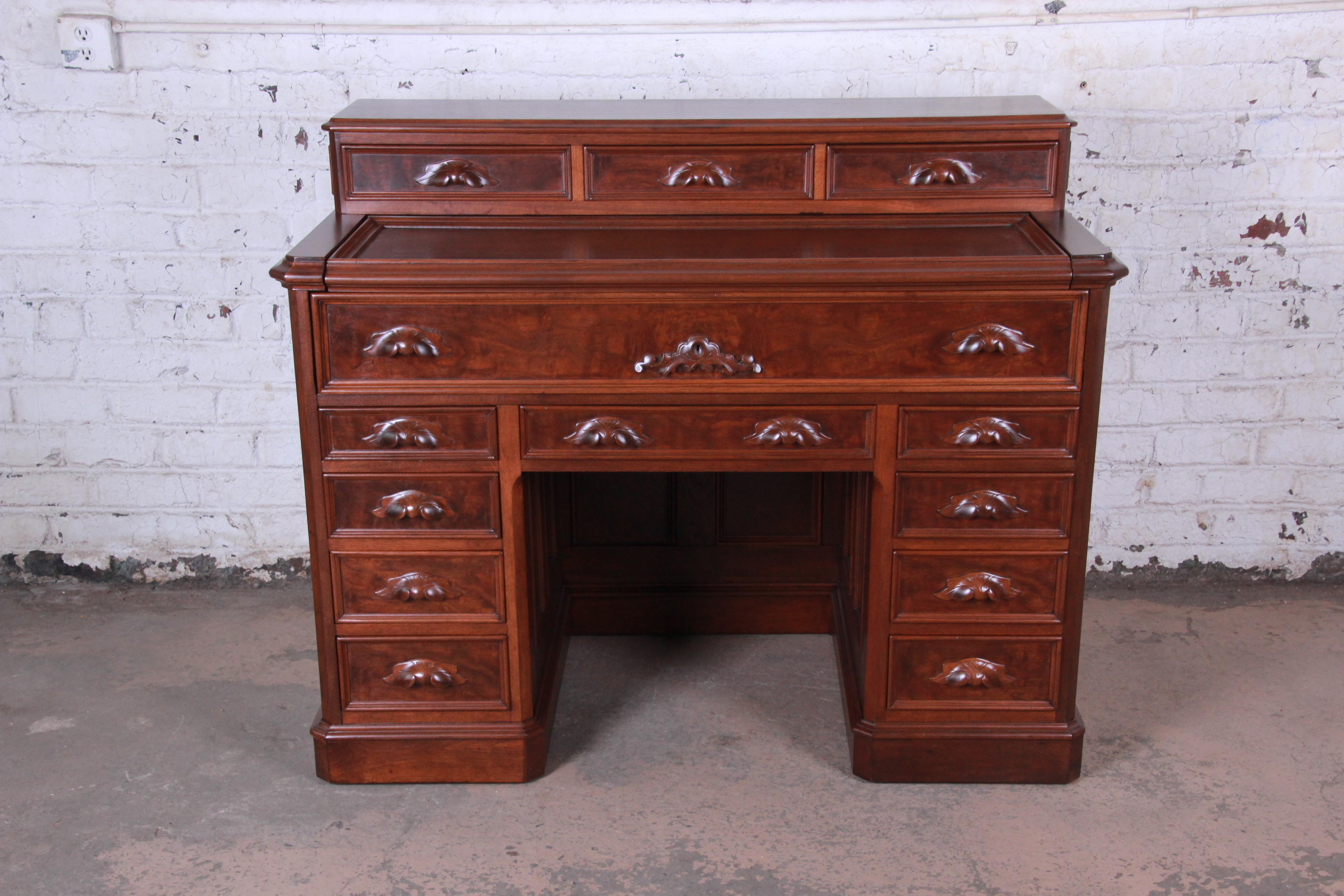 Offering an exceptional and truly one-of-a-kind 19th century Victorian carved mahogany railroad desk. The desk came from a Chicago railway station and was made by Tillman Silsbee & Co. of Detroit, MI, circa 1850. It features gorgeous flame mahogany