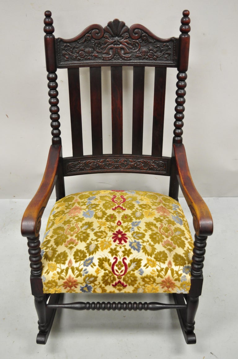 Antique rocking chair with carved face top