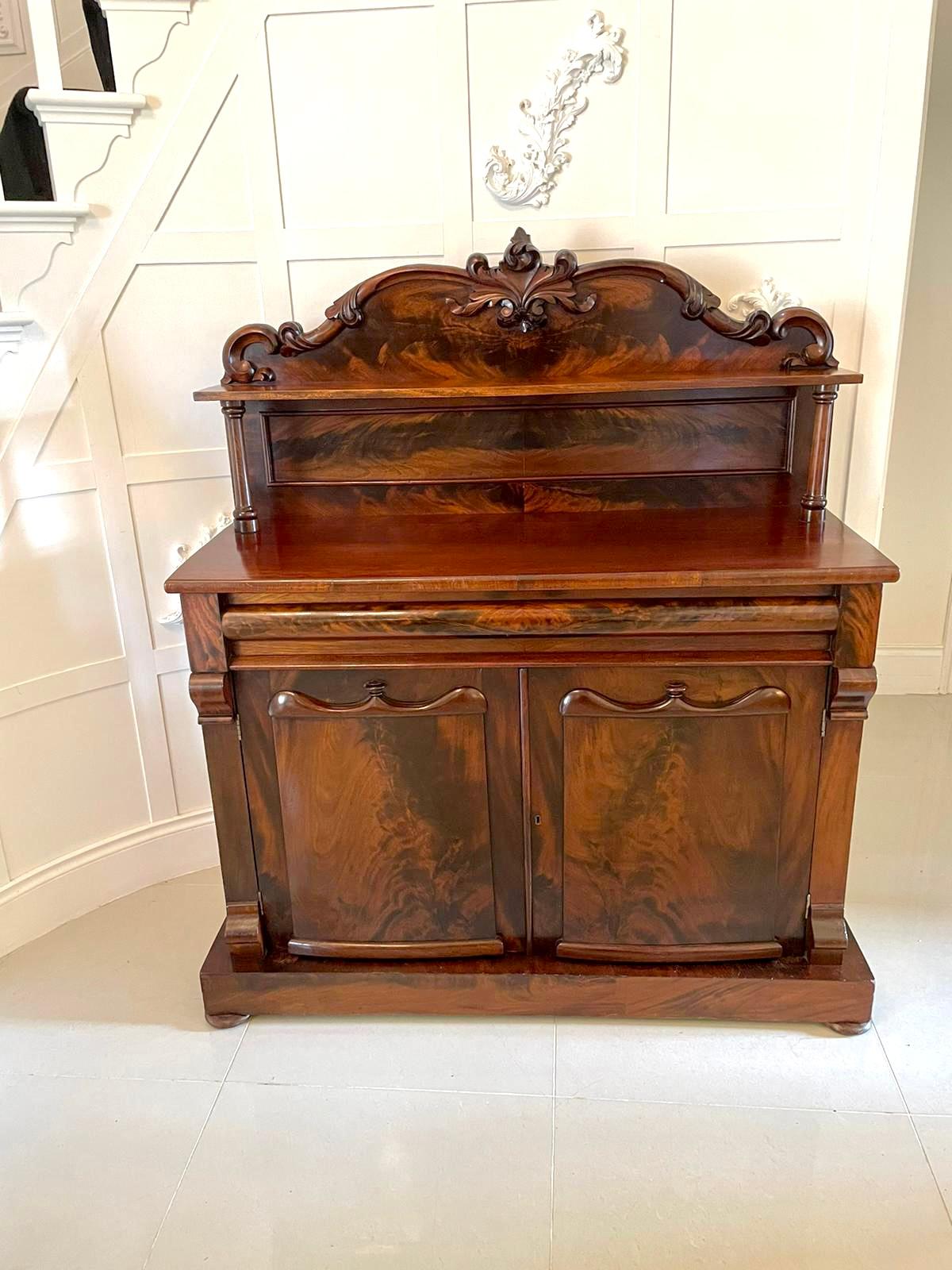 Antique Victorian carved mahogany sideboard having a quality attractive shaped carved mahogany back with a shelf supported by turned columns above a lovely mahogany top, shaped figured mahogany drawer to the frieze above a pair of figured mahogany
