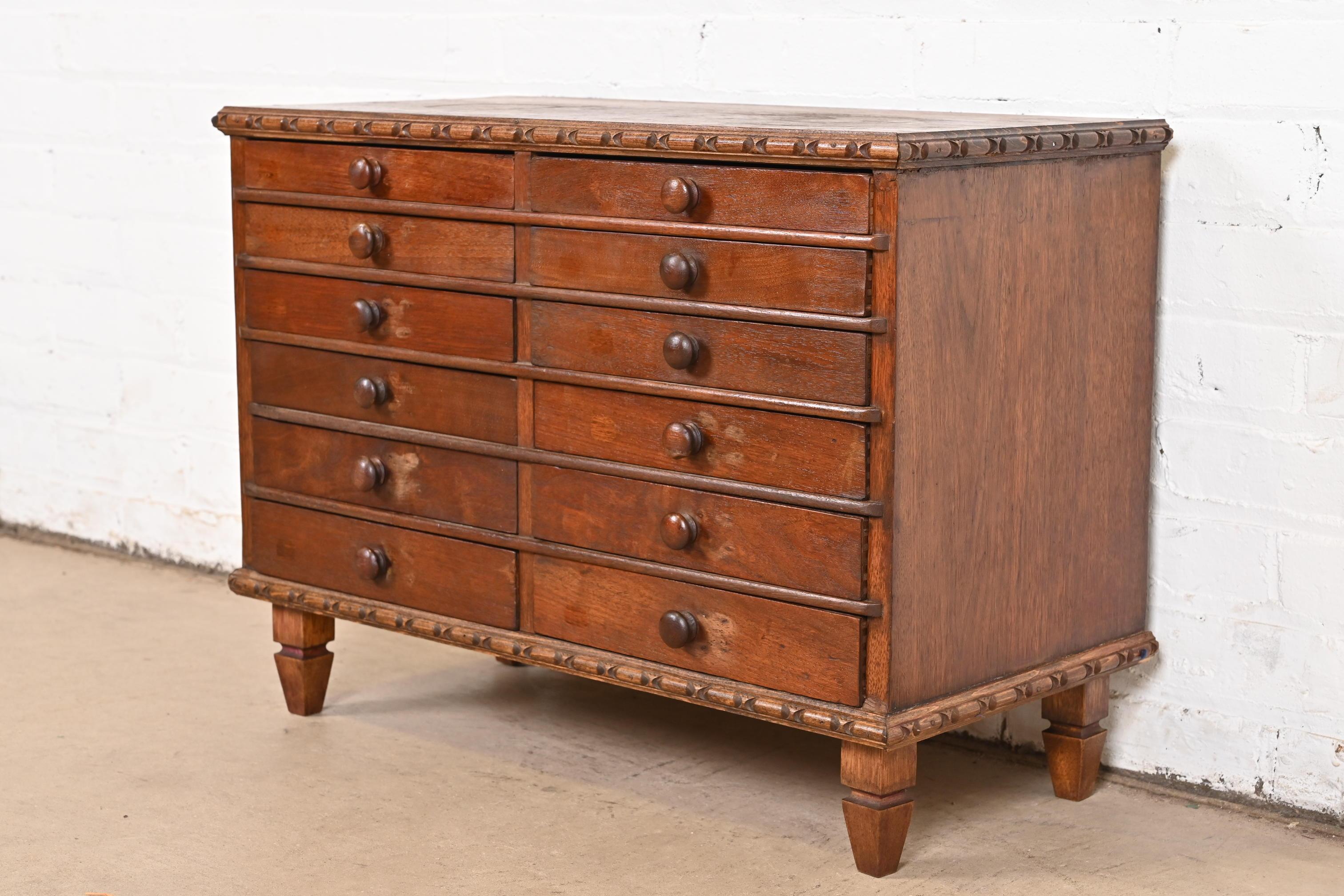 An exceptional Victorian carved mahogany twelve-drawer collector's cabinet

USA, Circa 1880s

Measures: 25.38