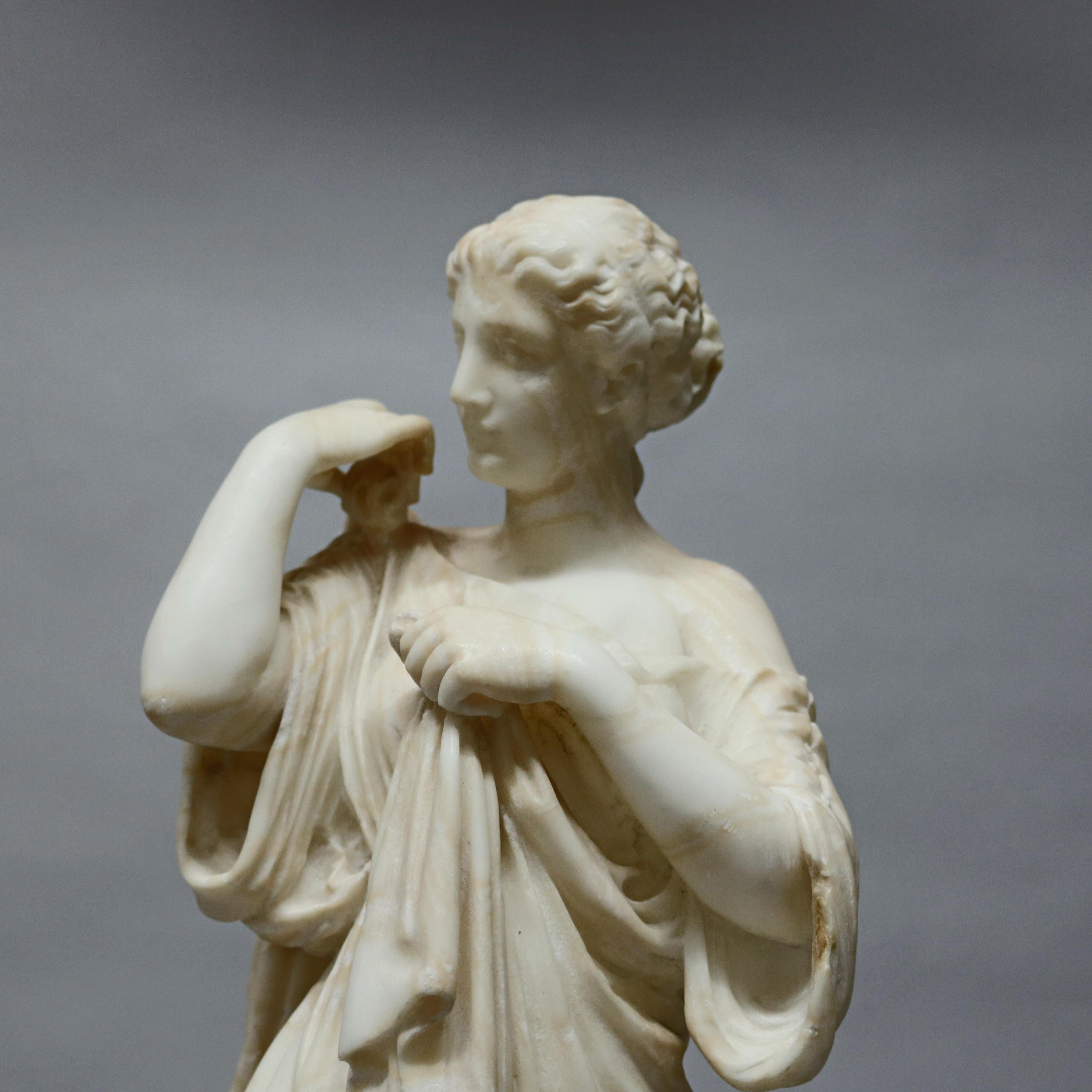 An antique Victorian carved marble sculpture depicts full length portrait of young Grecian woman in countryside setting, circa 1890.

Measures: 23.5