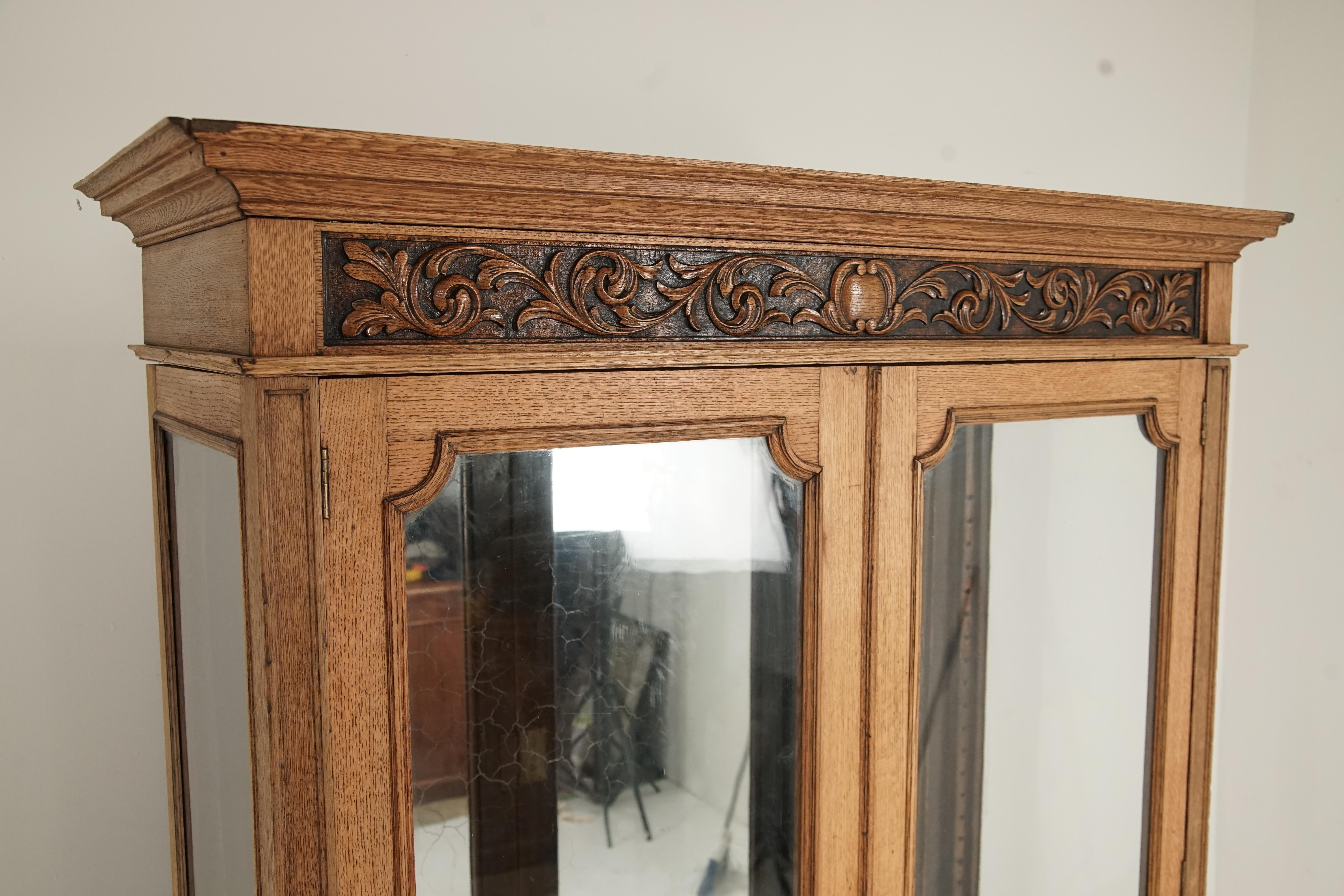 Large antique Victorian carved oak 2 door display China cabinet, Scotland 1890, H178

Scotland 1890
Solid oak
Original finish
Carved oak cornice on top
Pair of original oak glass doors below
Opens to reveal glass sides and crackling mirror on the