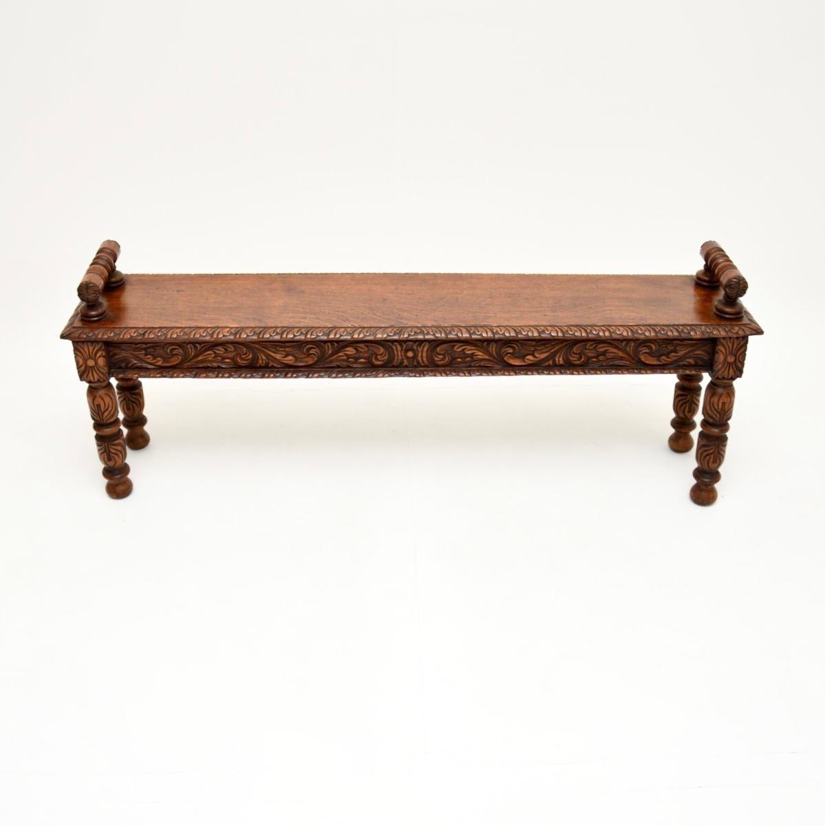 A wonderful antique Victorian carved oak bench, made in England and dating from around the 1870-1880 period.

It is of outstanding quality, with profuse and intricate carving throughout. It is a great size, perfect for use as an entry way bench, at