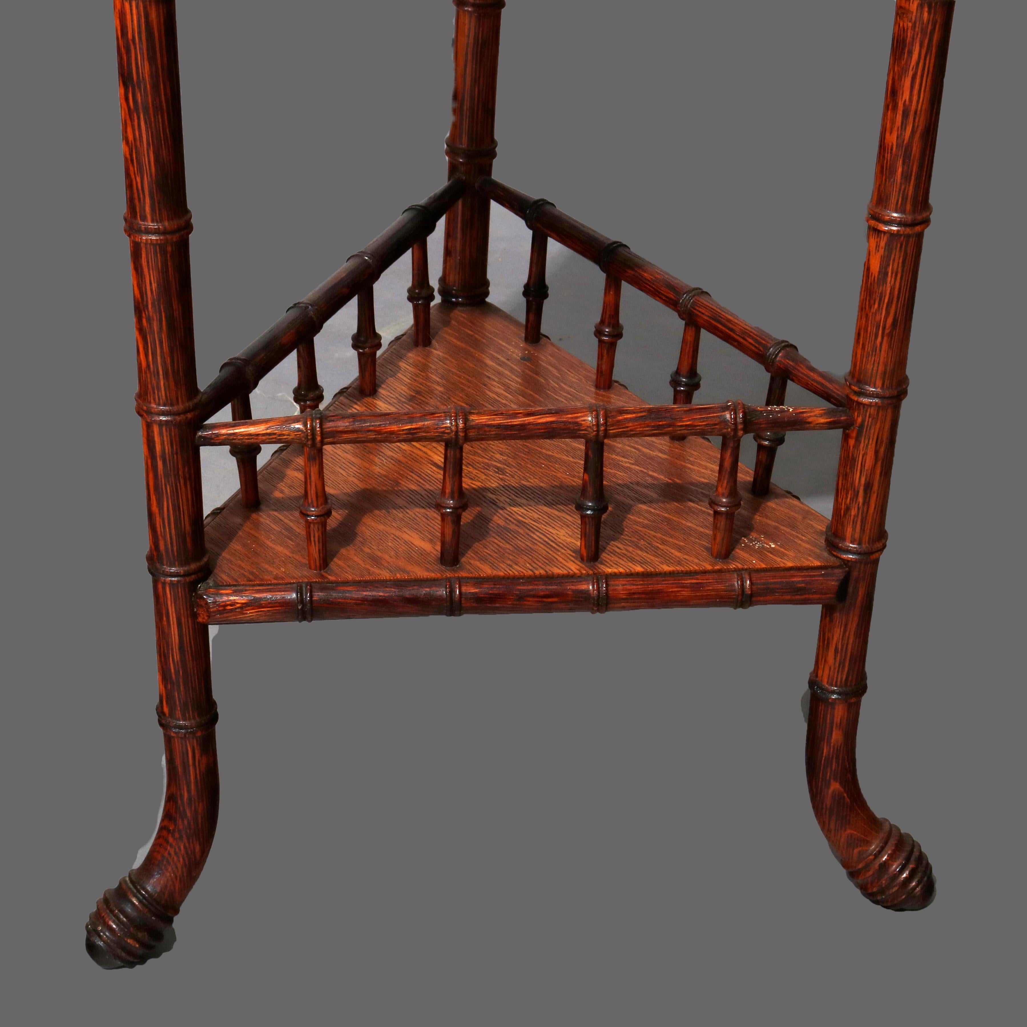 An antique Victorian side table offers carved oak construction in faux bamboo form with triple drop leaf top with lower triangular shelf with gallery, circa 1900

***DELIVERY NOTICE – Due to COVID-19 we are employing NO-CONTACT PRACTICES in the