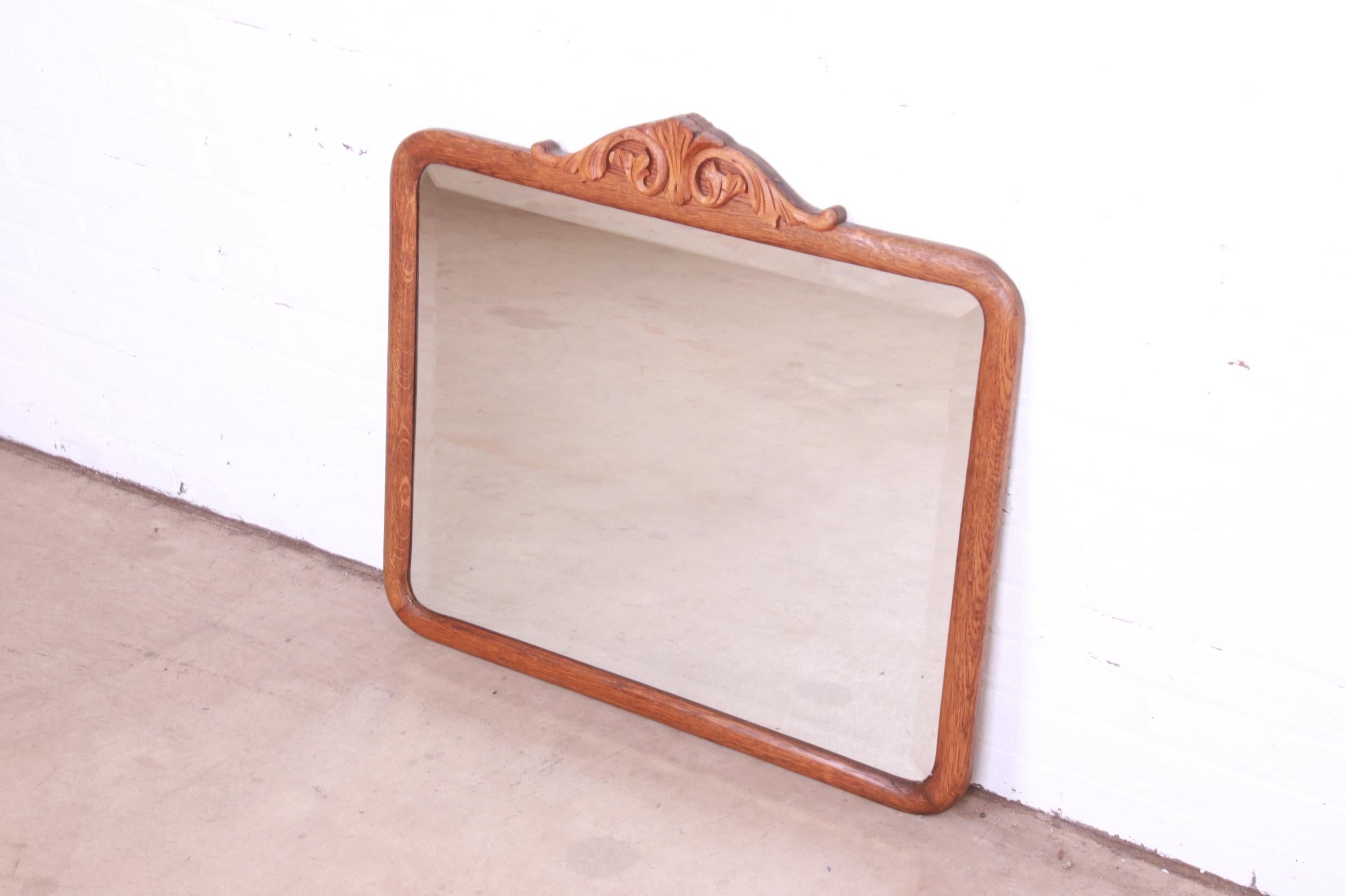 A gorgeous antique Late Victorian or Arts & Crafts wall mirror

USA, Early 20th Century

Carved solid oak frame, with beveled mirror.

Measures: 30.75