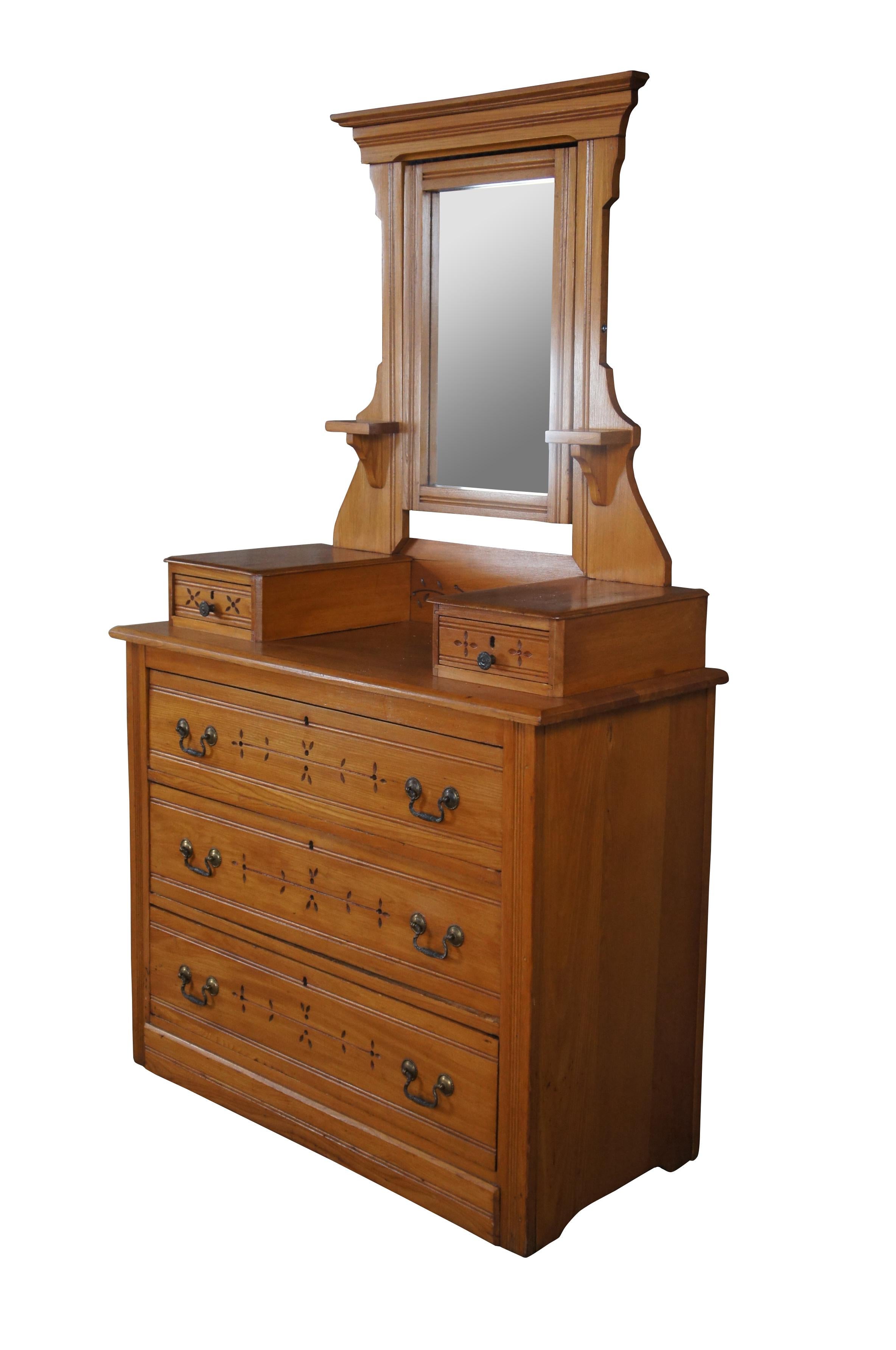 A late Victorian stepback dresser and mirror, circa 1900s. Made from pine with carved foliate detail. Features three large lower dovetailed drawers and two upper glovebox or handkerchief drawers. Features a swivel mirror along the back flanked by