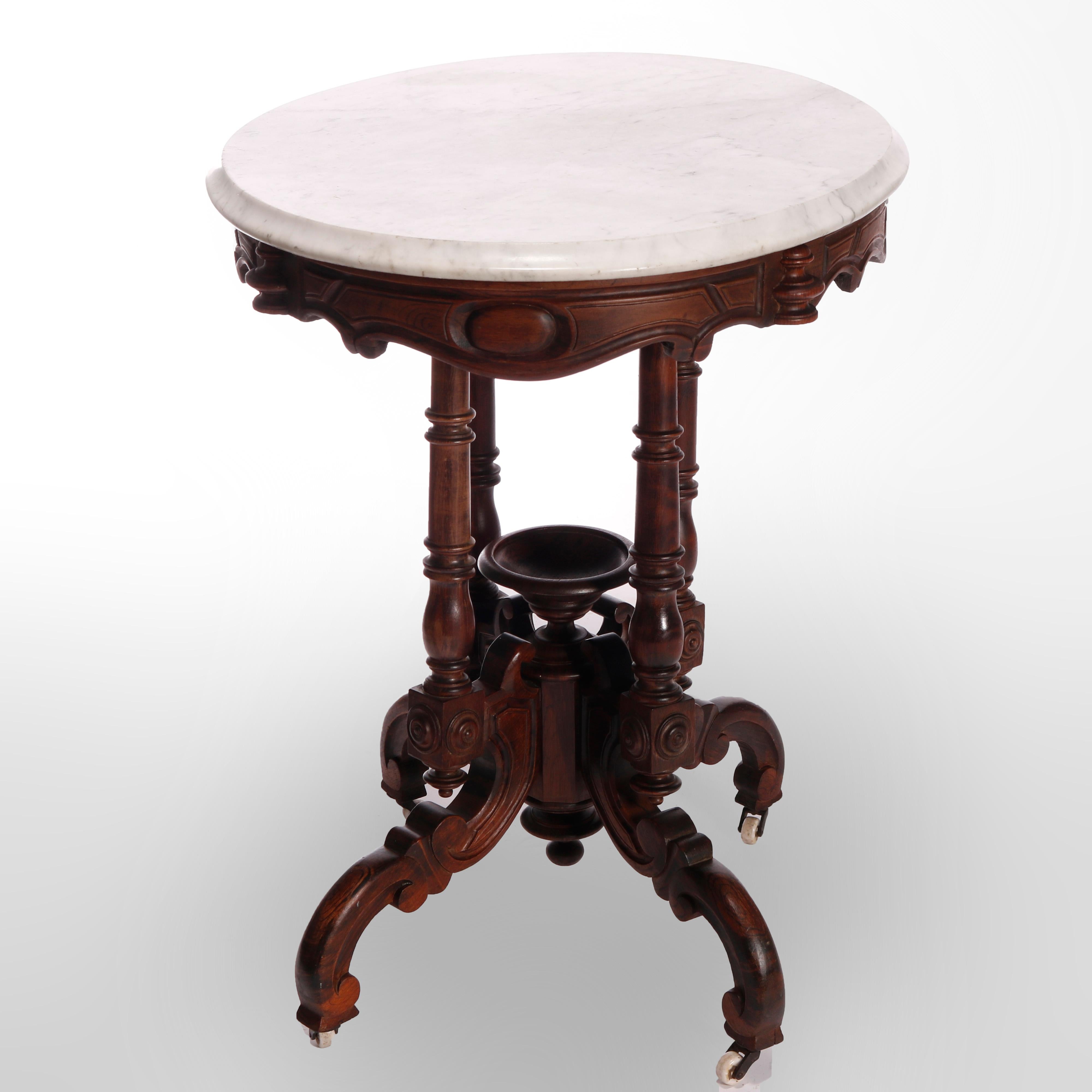 An antique Victorian parlor table offers beveled marble top over rosewood base having carved scroll form skirt raised on four turned columns having central urn form finial and scroll form legs, c1880

Measures - 29'' H x 30'' W x 22'' D.

Catalogue