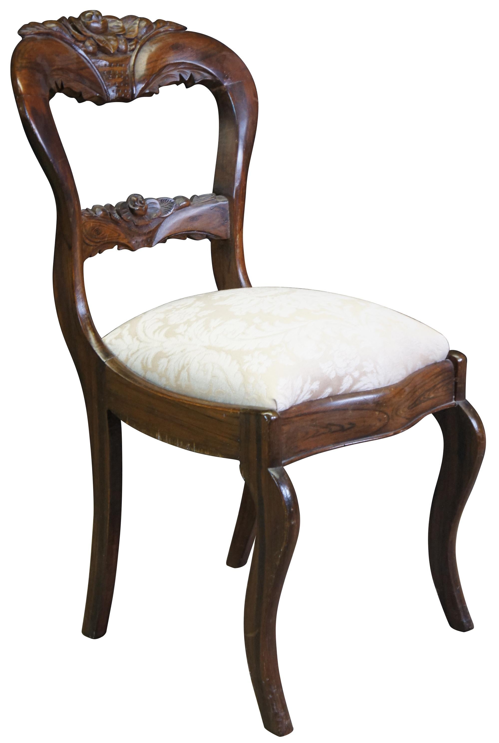 A stunning mid 19th century balloon back chair. Beautifully carved with floral crest rail and slat. Features a deep brown finish with visually appealling wood grain and brocade uphostered seat.
 
