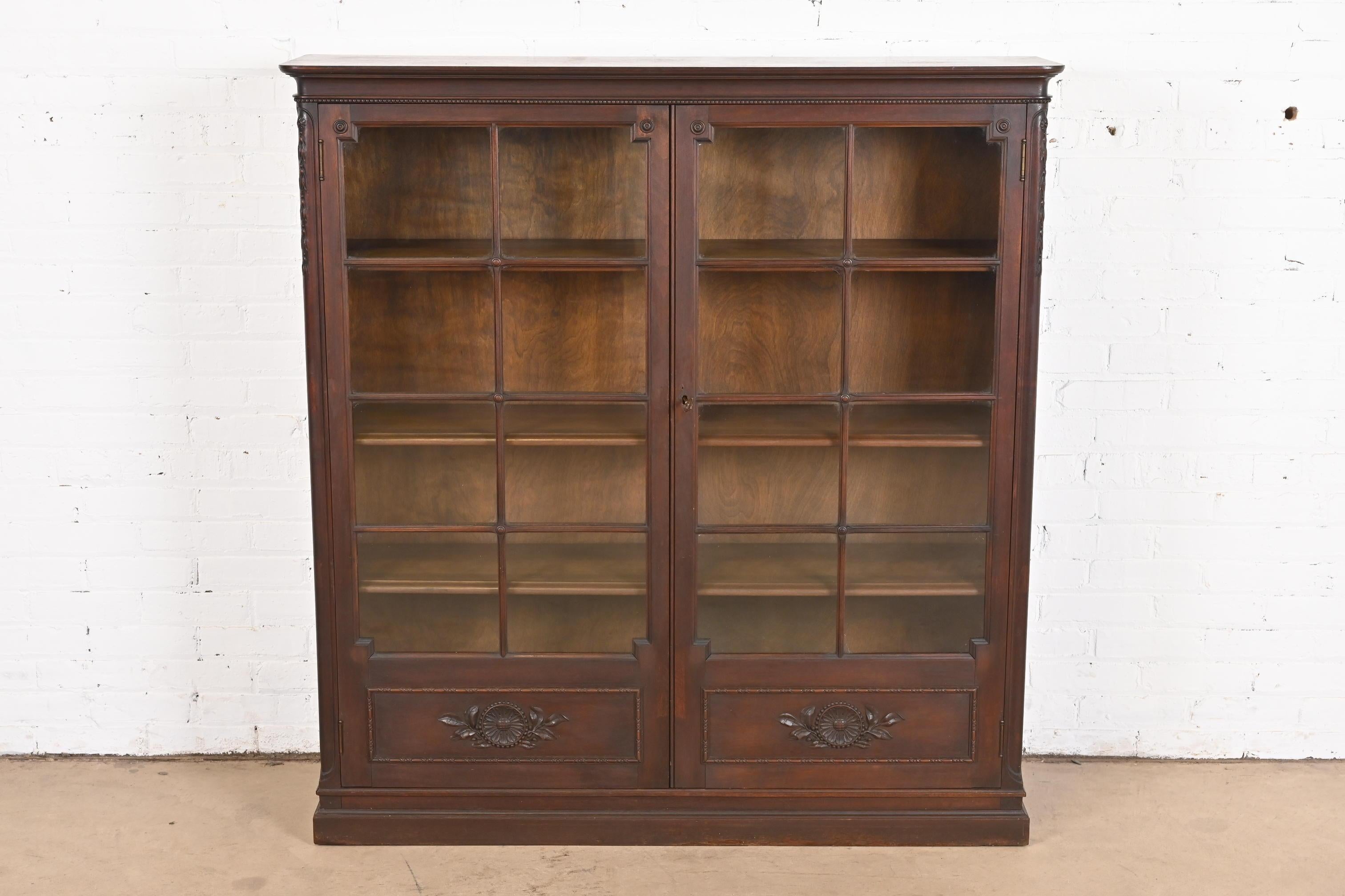 A gorgeous antique Late Victorian or Arts & Crafts bookcase

By Berkey & Gay

USA, Circa 1900

Carved walnut, with mullioned glass front doors.

Measures: 50.25