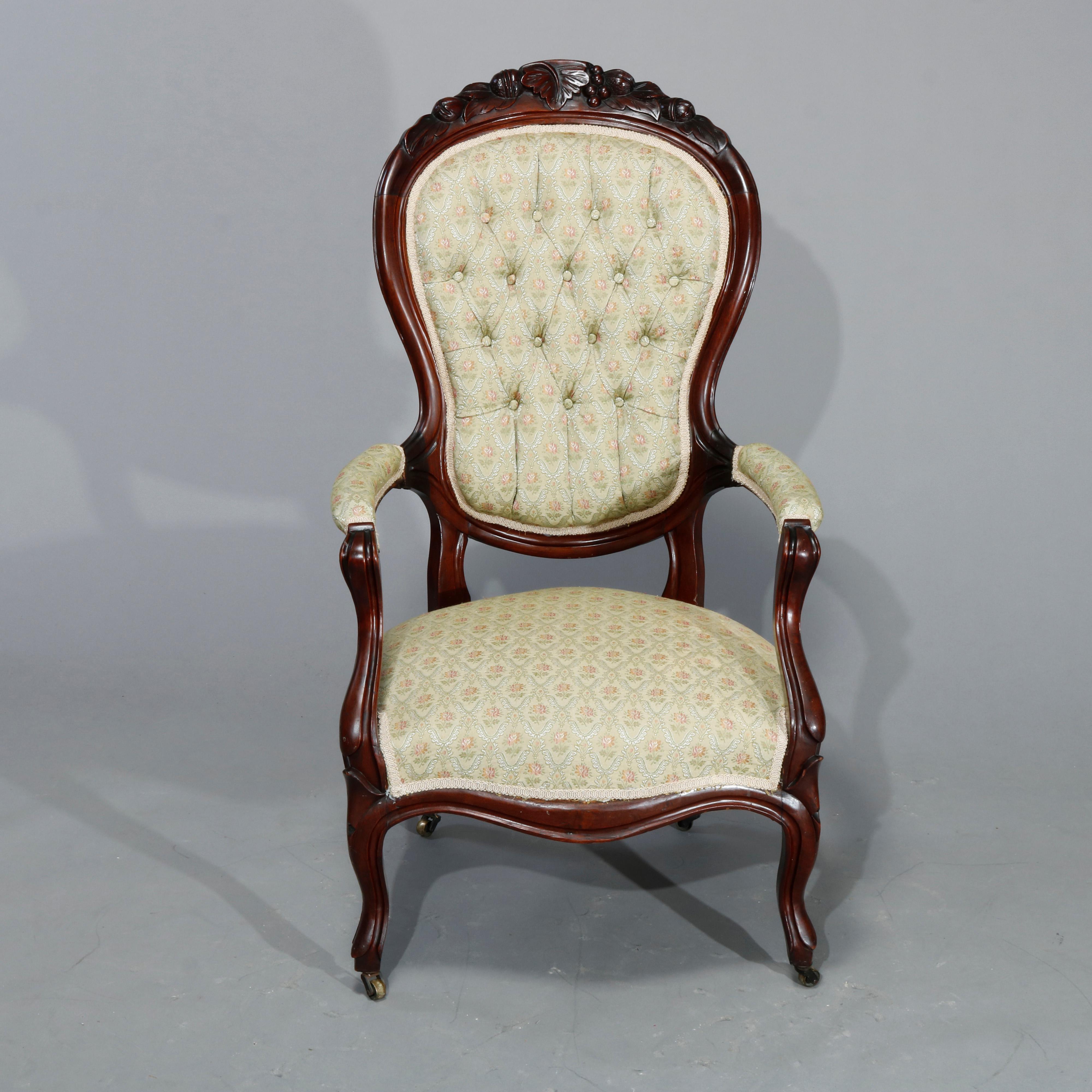 An antique Victorian parlor set offers gentleman's armchair and lady's chair with carved walnut frames having shaped backs with foliate carved crests, button back upholstered, raised on cabriole legs, c1890.

Measures: 40.25