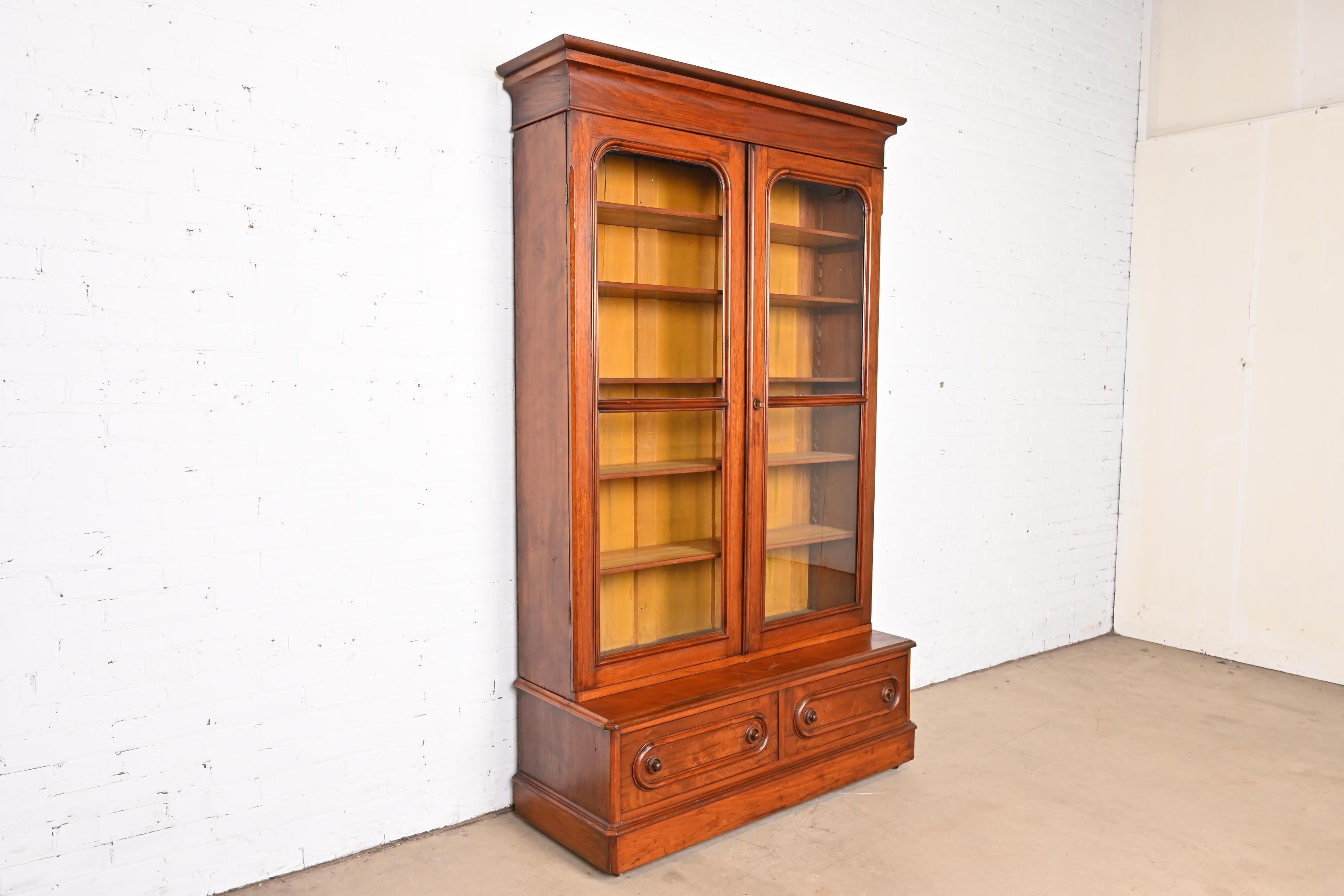 Antique Victorian Carved Walnut Glass Front Bookcase Cabinet, Circa 1880s In Good Condition For Sale In South Bend, IN