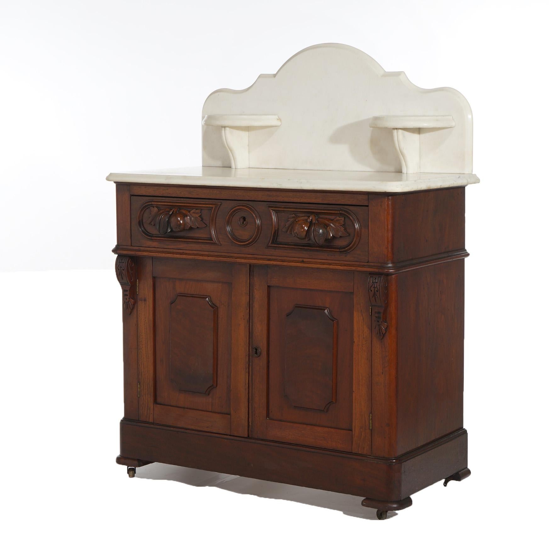 ***Ask About Reduced In-House Delivery Rates - Reliable Professional Service & Fully Insured***
Antique Victorian Carved Walnut Marble Top Commode Wash Stand with Candle Stands and Fruit and Foliate Elements C1890

Measures - 44.5