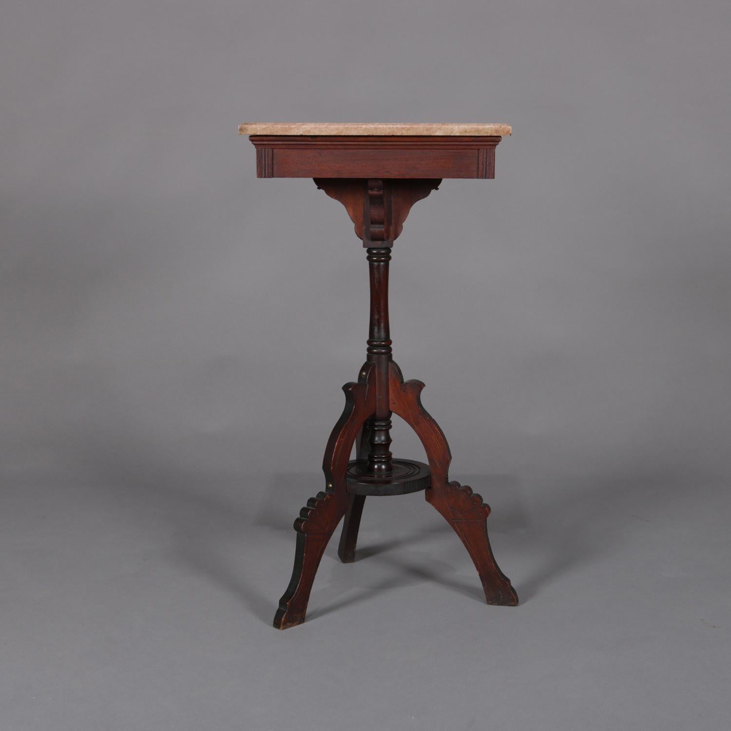 Antique Victorian Eastlake plant display stand features beveled marble top seated on carved walnut base with turned column and seated on three carved and shaped legs, circa 1890

Measures: 31