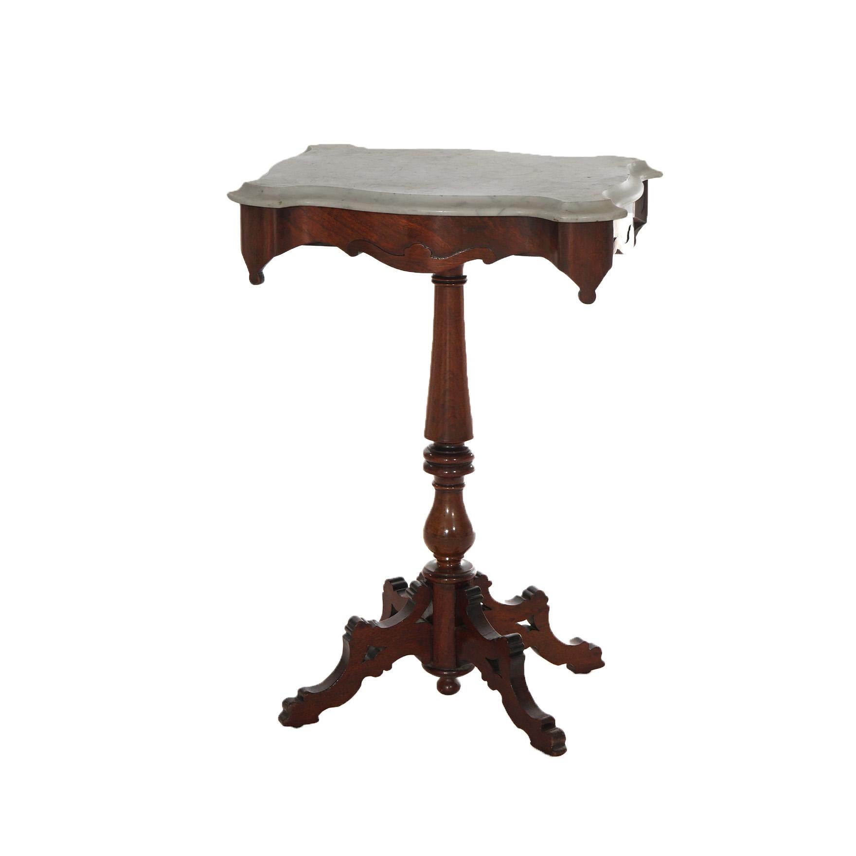 An antique Victorian side table offers shaped and beveled marble top over carved walnut base with shaped skirt, turned column and raised on four legs, c1880

Measures - 28.5