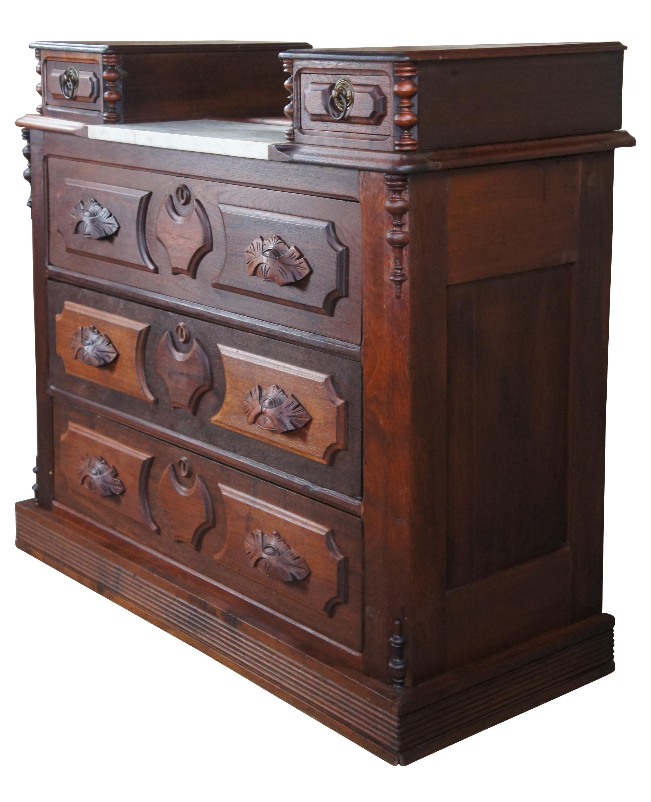 circa 1880s Victorian dresser. Made from walnut with two glovebox drawers flanking a marble insert and three larger lower hand dovetailed drawers. Features paneled drawer trim, chamfered corners, quarter cut turned spindles, leaf carved pulls, brass