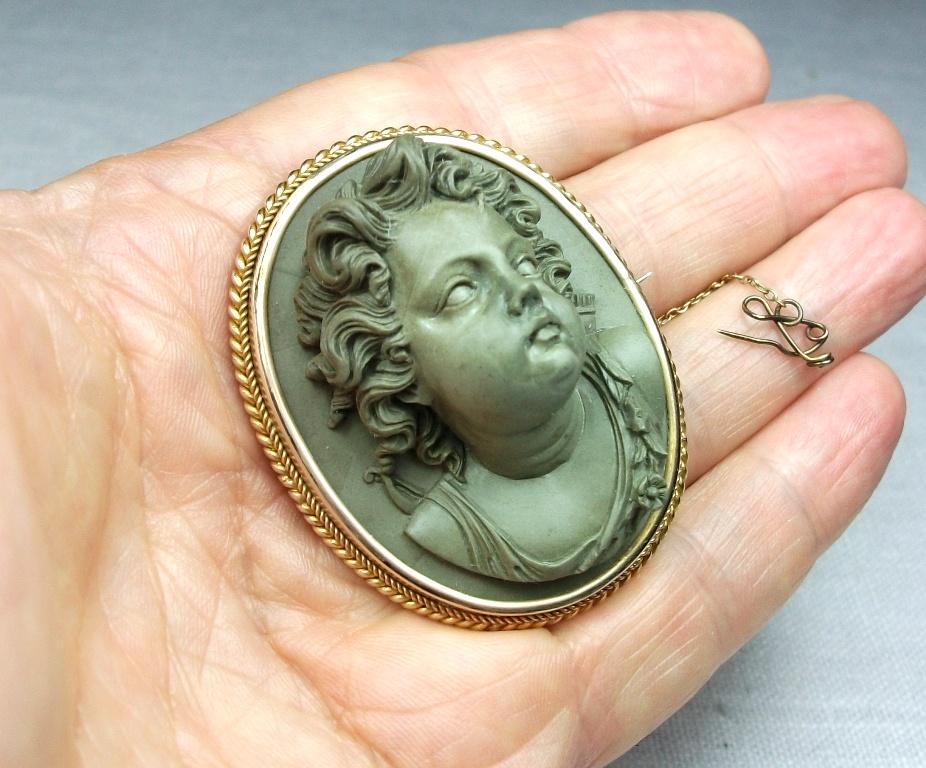Museum Quality and rarest lava stone cameo brooch depicting Cupid in front face. In the Victorian era Cupid (Eros in Greek Mythology) was often found in cameos and antique jewellery as the symbol of love. This one is an artwork and in really mint