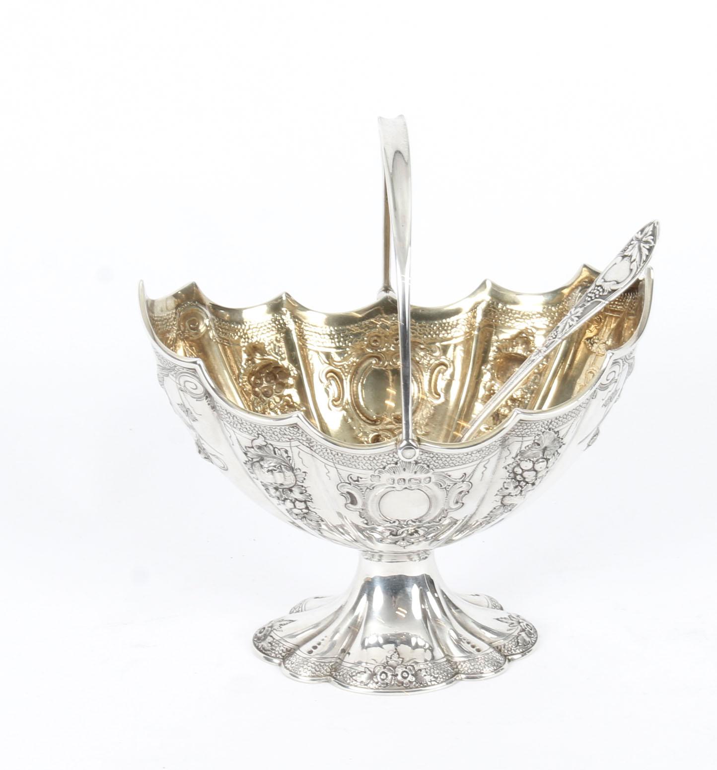 This is a delightful cased Victorian sterling silver sugar bowl and matching sugar sifter bearing hallmarks for Sheffield 1868 and the makers mark of the renowned silversmith Martin Hall & Co.

The sugar bowl of oval helmet form with repousse