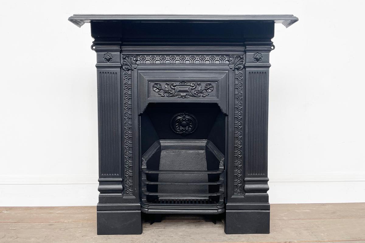 An ornate late Victorian cast iron bedroom combination fireplace. Circa 1885.

Fully restored and finished in a heat resistant matte black spray paint. We can change this finish if required.

For detailed sizes please see the size diagram in the