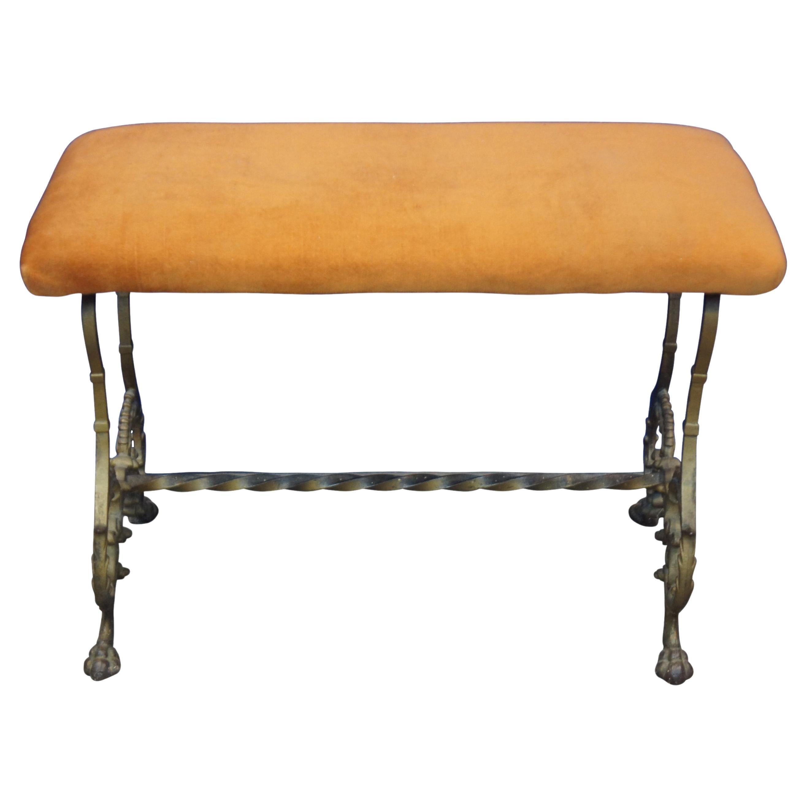 Antique Victorian vanity seat or piano bench with a gilded iron trestle base, paw feet and an orange velour upholstered top.
 