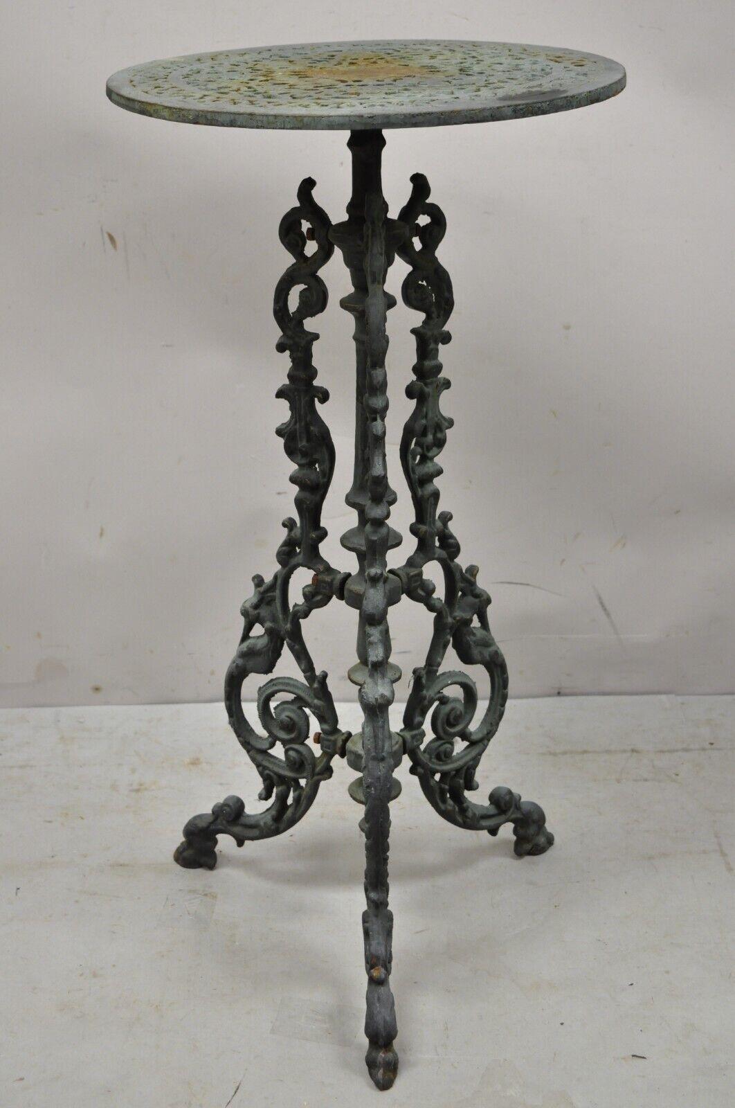 Antique Victorian cast iron green ornate plant stand tripod pedestal table. Item features heavy cast iron construction, ornate tripod pedestal base, pierced top, very nice antique item. Circa early 1900s. Measurements: 30